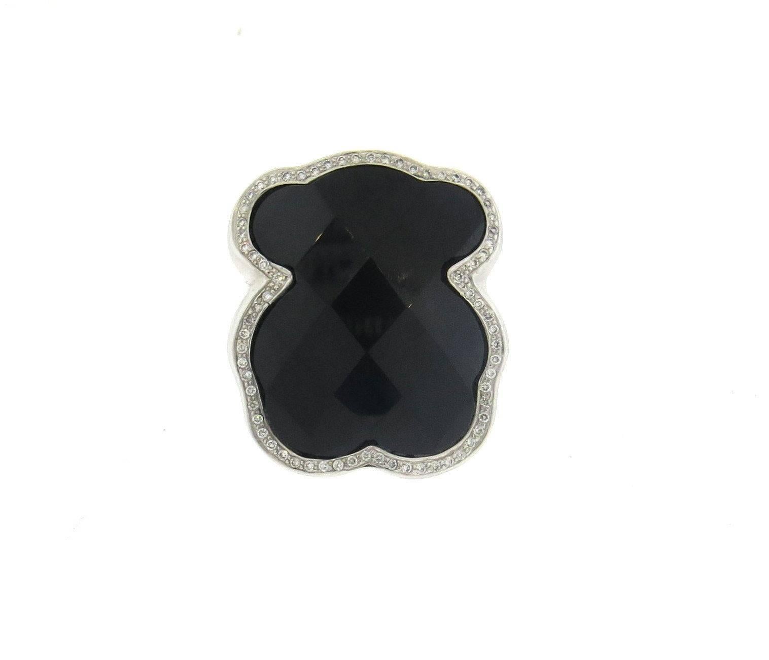 An 18k white gold ring set with faceted onyx and approximately 0.42ctw of G/VS diamonds.  Crafted by Tous, the ring is a size 5, ring top is 32mm x 28mm.  The weight of the ring is 24.6 grams.
