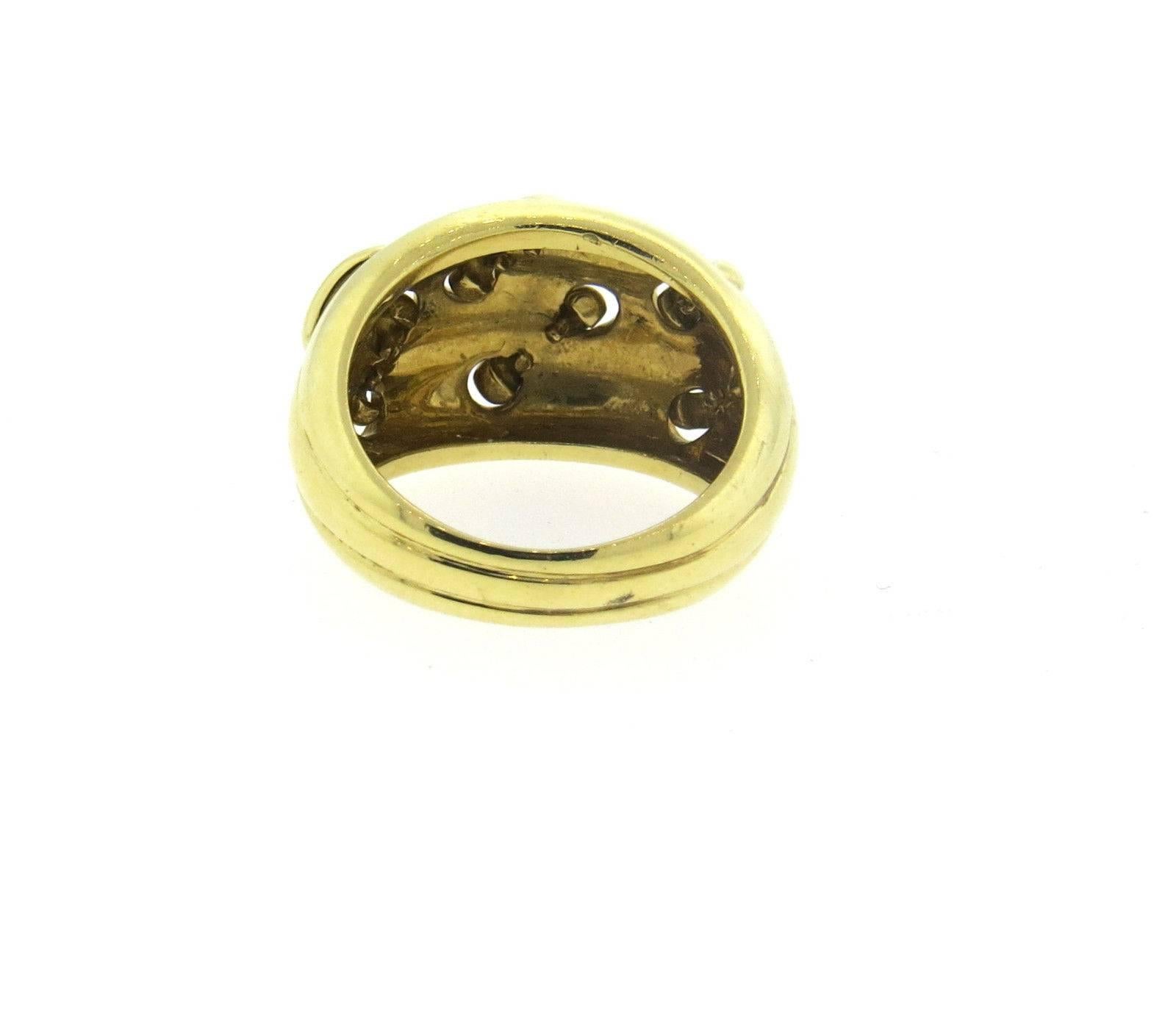 An 18k yellow gold ring in a stitch motif.  Crafted by Tiffany & Co, the ring is a size 6 1/2, ring top is 13.5mm wide. Marked: Tiffany & Co, 750.  The weight of the piece is 10.5 grams. 
