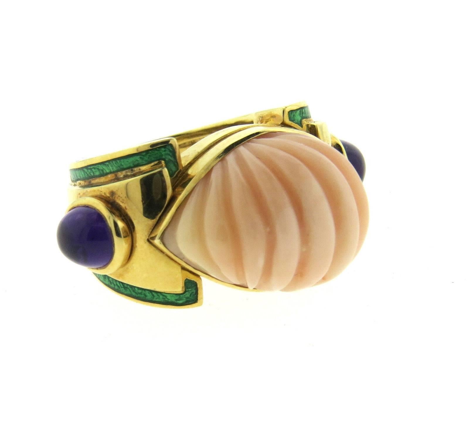 An 18k yellow gold ring set with amethyst cabochons and carved coral (*has natural imperfection on one side - please see picture*). Crafted by David Webb, the ring is a size 6 and the ring top is 16mm x 32mm.  Marked: Webb, 18k.  Weight: 27.8 grams.