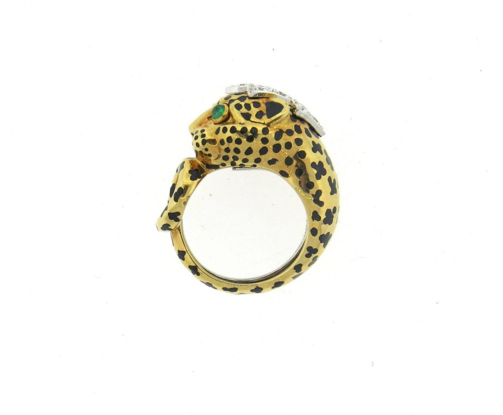 An 18k yellow gold and platinum leopard ring set with approximately 0.45ctw of GH/VS diamonds and emerald eyes.  Crafted by David Webb, the ring is a size 6, ring top is 13mm wide.  Marked: Webb plat 18k.  The weight of the ring is 14.3 grams.