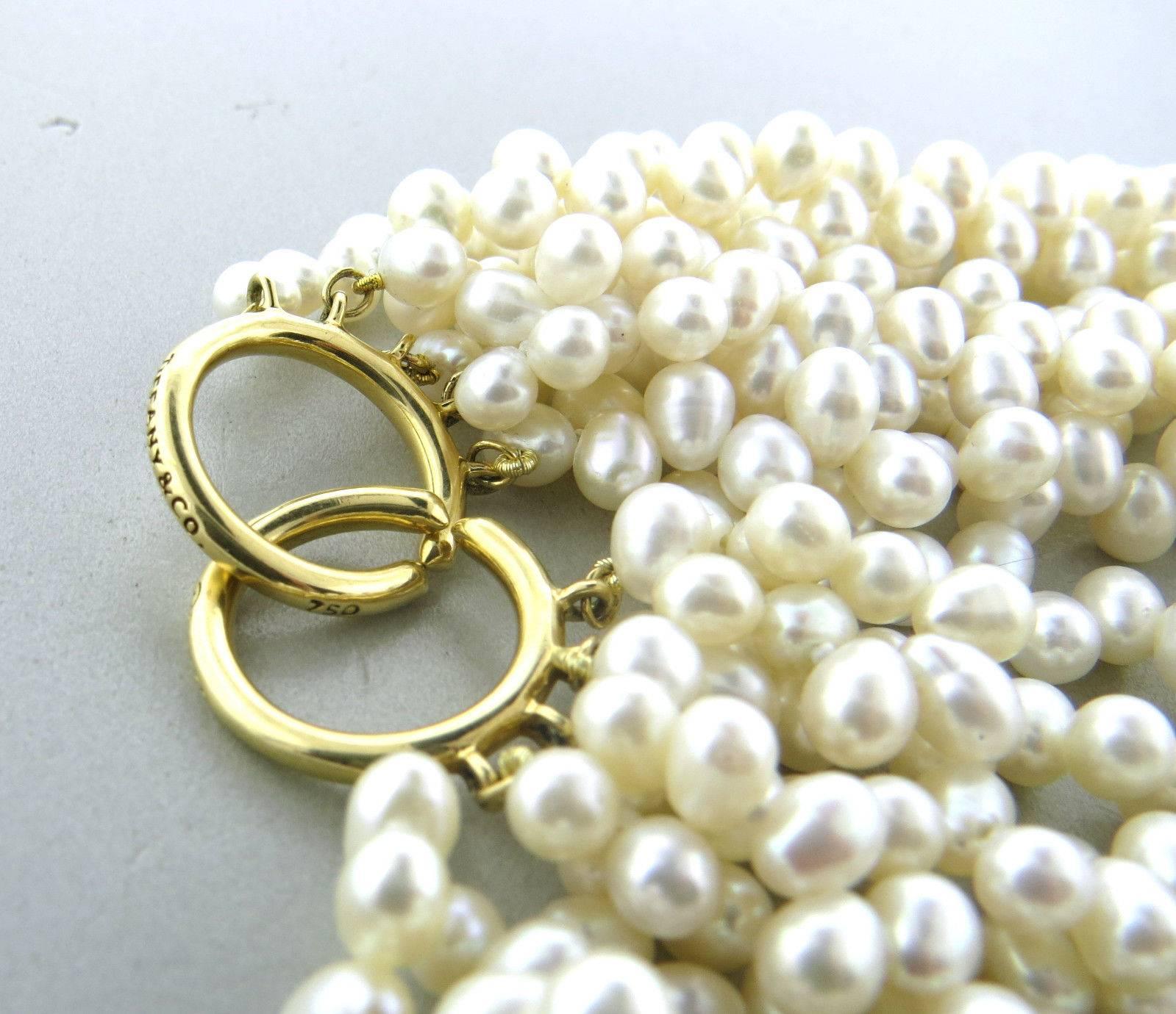 An 18k yellow gold necklace set with freshwater pearls approx. 6.5mm x 5mm.  Crafted by Tiffany & Co, the necklace is 16