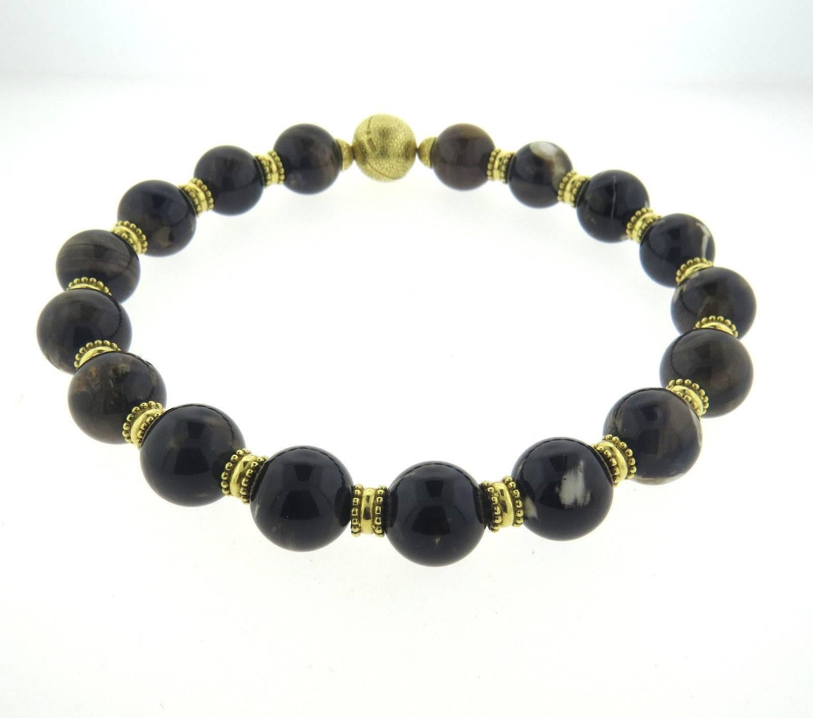 An 18k yellow gold necklace set with agate beads ranging from 17.7mm - 18.5mm in diameter.  Crafted by Elizabeth Gage, the Necklace is 15 3/4