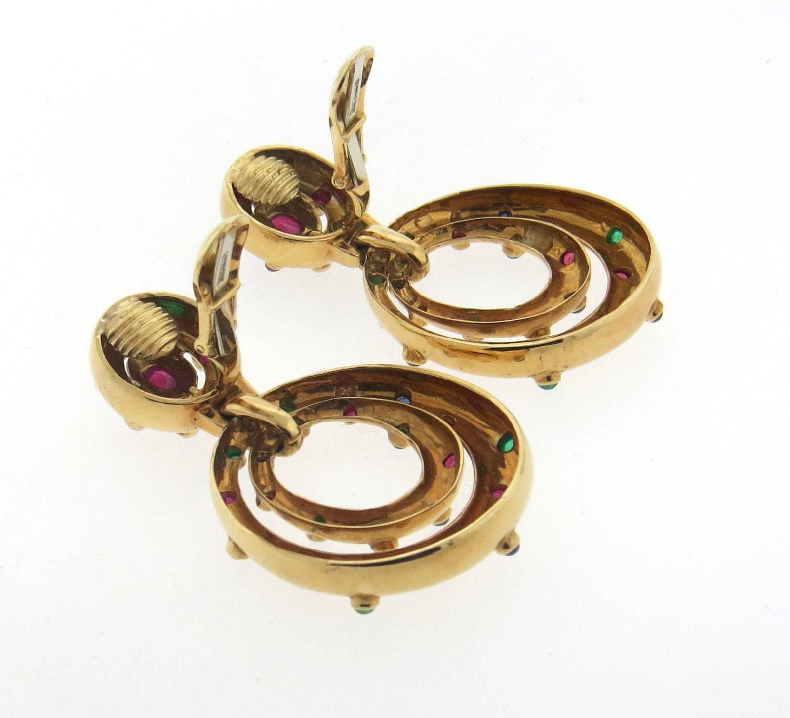 A pair of 18k yellow gold earrings set with sapphire, emerald and ruby cabochons.  Crafted by David Webb, the earrings measure 55mm long x 32mm wide and weigh 39.6 grams.  Marked: Webb, 18k