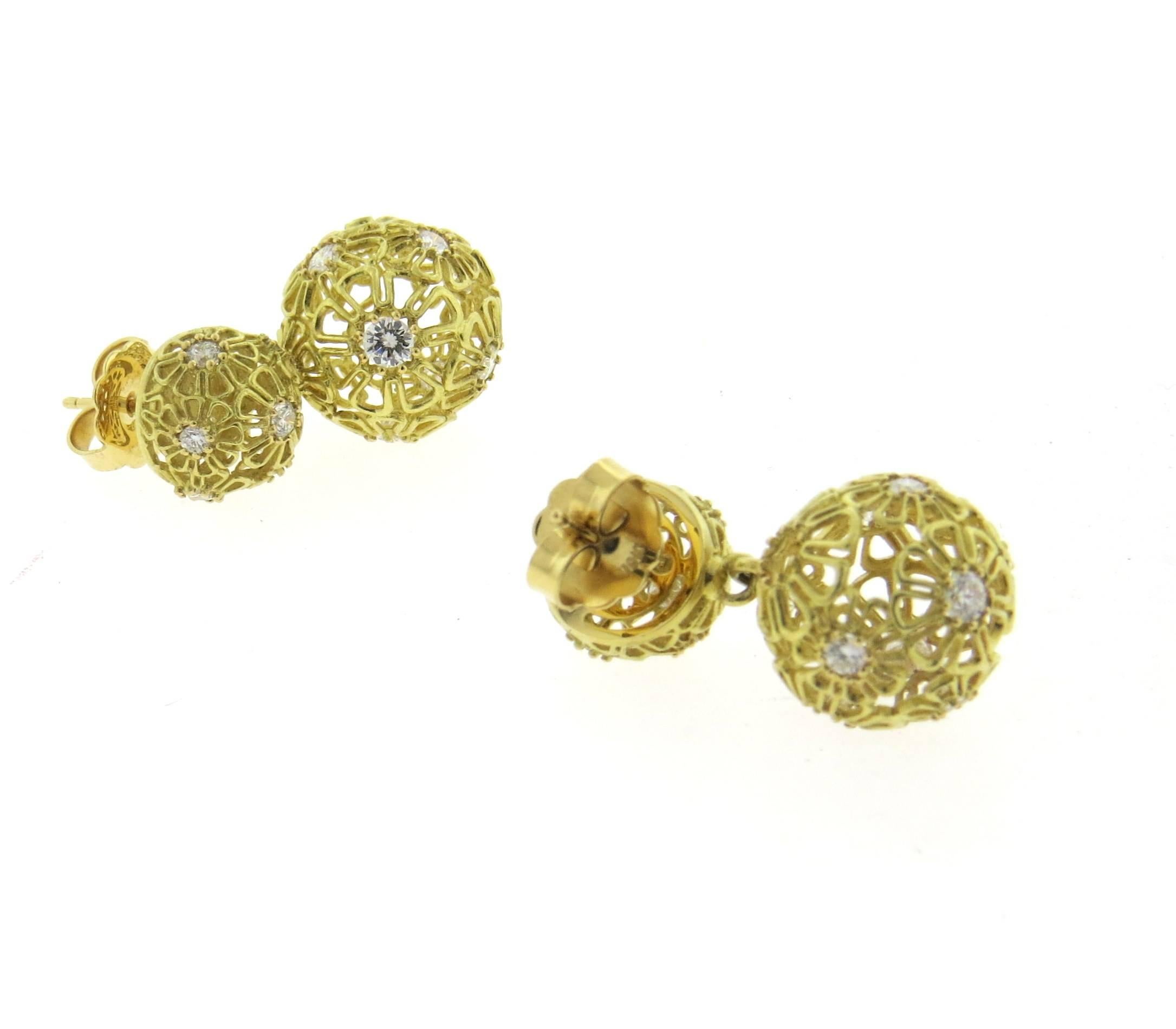 A pair of 18k yellow gold drop earrings, featuring two balls with flower designs, set with approx. 2.50ctw in diamonds. Earrings are 30mm long x 16mm wide (diameter of bottom ball). Marked: Morelli 750. Weight - 13.4 grams
Retail $12800