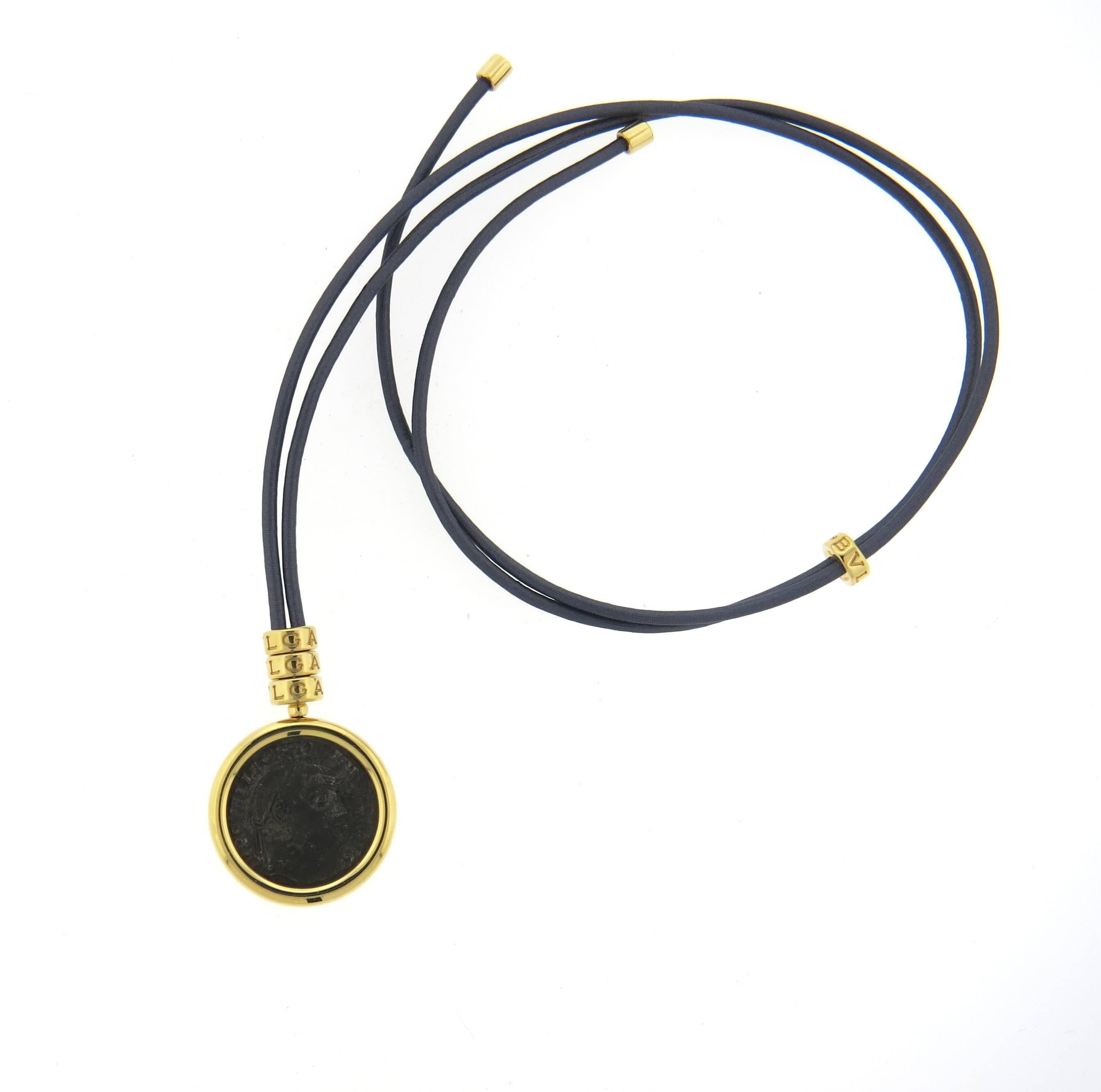 An 18k yellow gold and cord necklace, crafted by Bvlgari for Monete collection, featuring 21mm Ancient Coin. Necklace is adjustable in length up to 27
