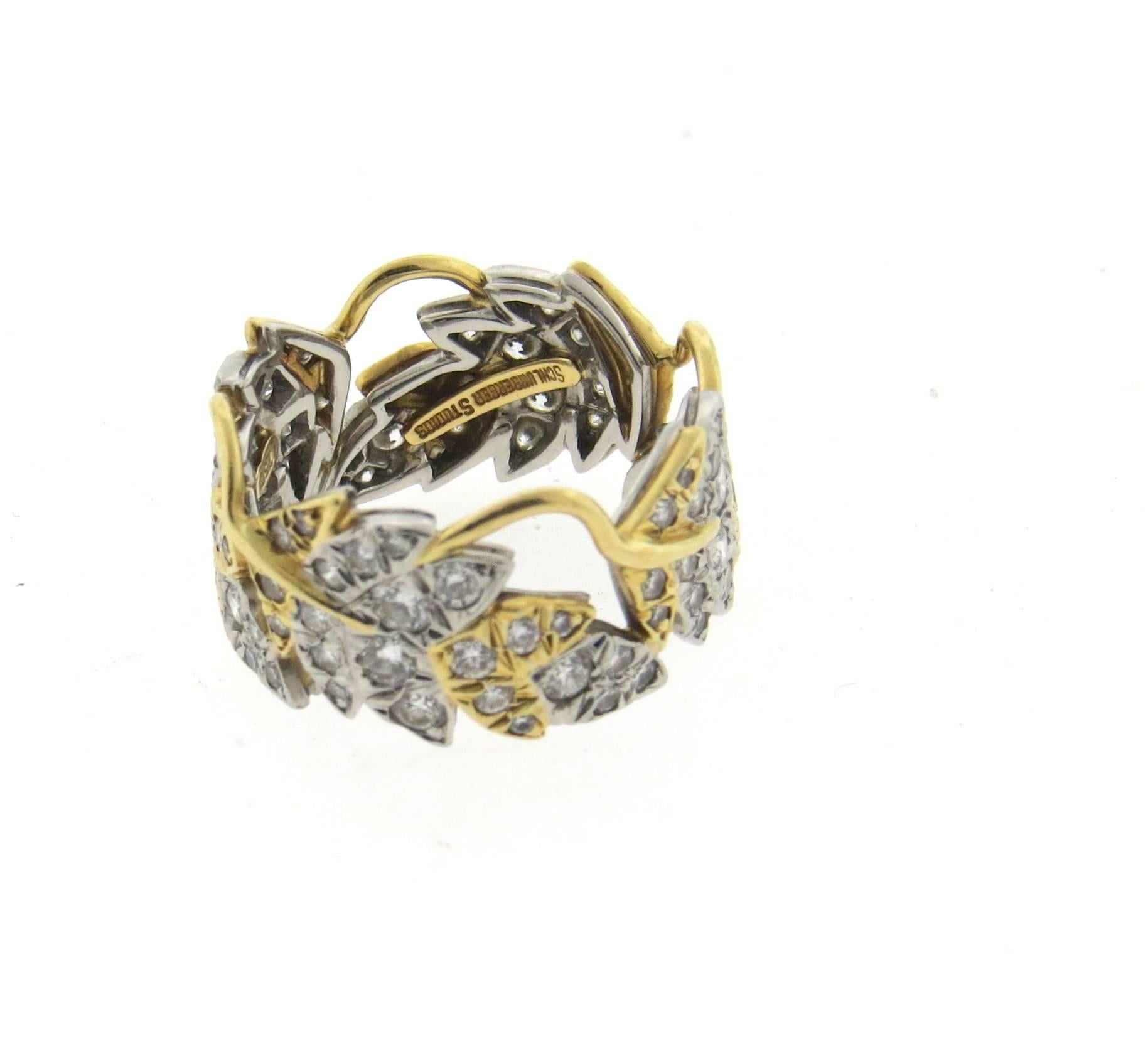 An 18k gold and platinum band ring, crafted by Jean Schlumberger for Tiffany & Co, from Four Leaves collection. Ring is decorated with 1.60ctw in G/VS diamonds. Ring is a size 6 and is 10.5mm wide. Marked: 750, pt950, Tiffany & Co, Schlumberger