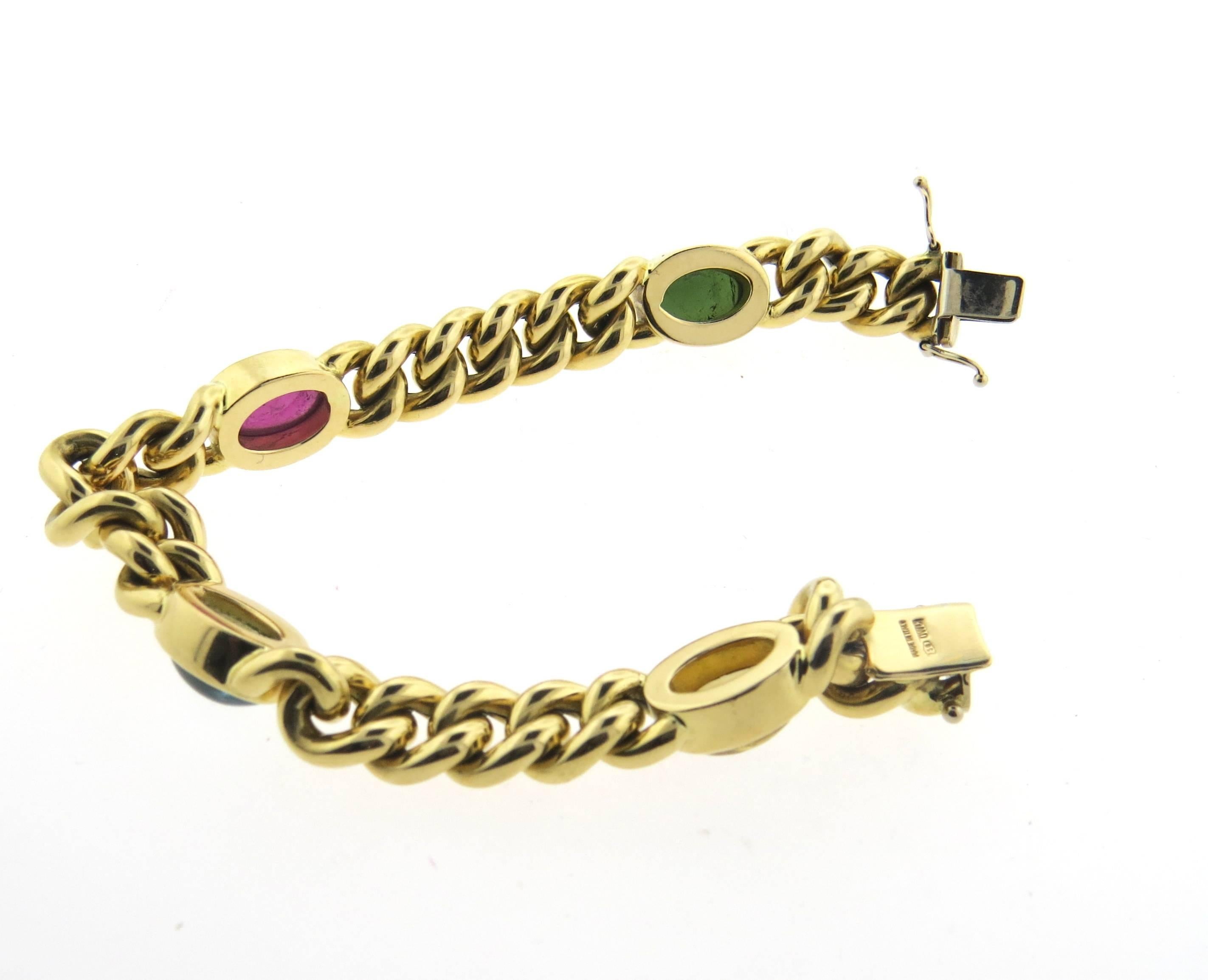 An 18k yellow gold bracelet, crafted by Italy, featuring four gemstone cabochons - pink and green tourmalines, citrine and blue topaz. Bracelet is 7 3/4