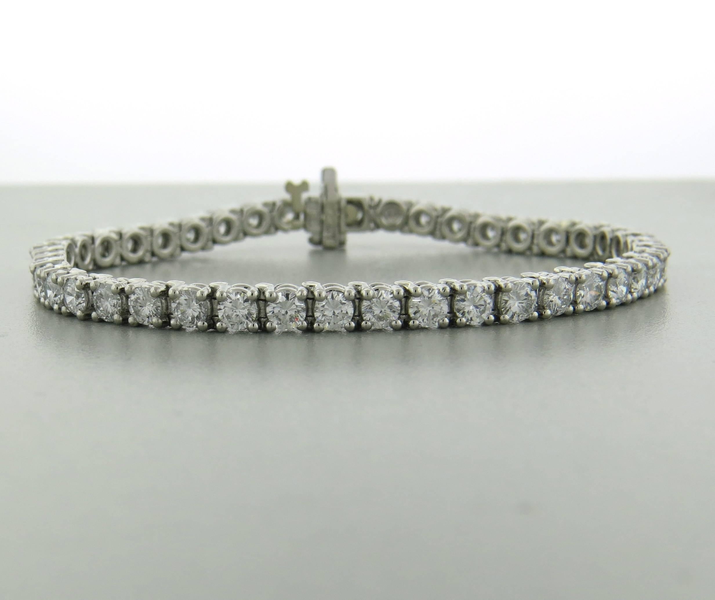 Platinum tennis bracelet, set with approximately 7 carats in VS1-SI1/H diamonds. Bracelet is 7 1/4" long and 4.2mm wide. Weight of the piece - 26.5 grams