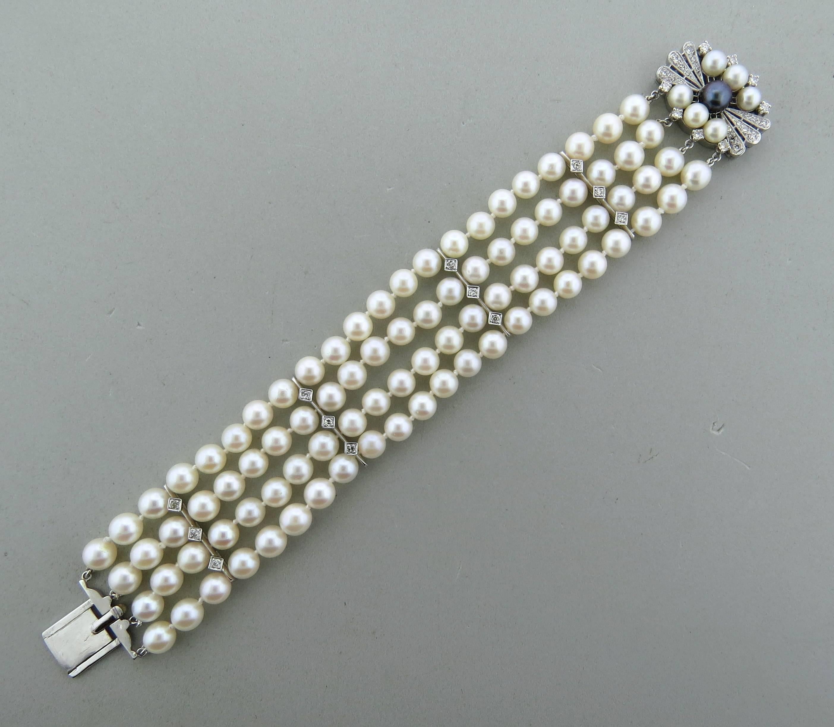 Mid century 24k white gold four strand bracelet, decorated with approx. 6.2mm to 7mm pearls and approx. 0.63ctw in diamonds. Bracelet is 7 1/4