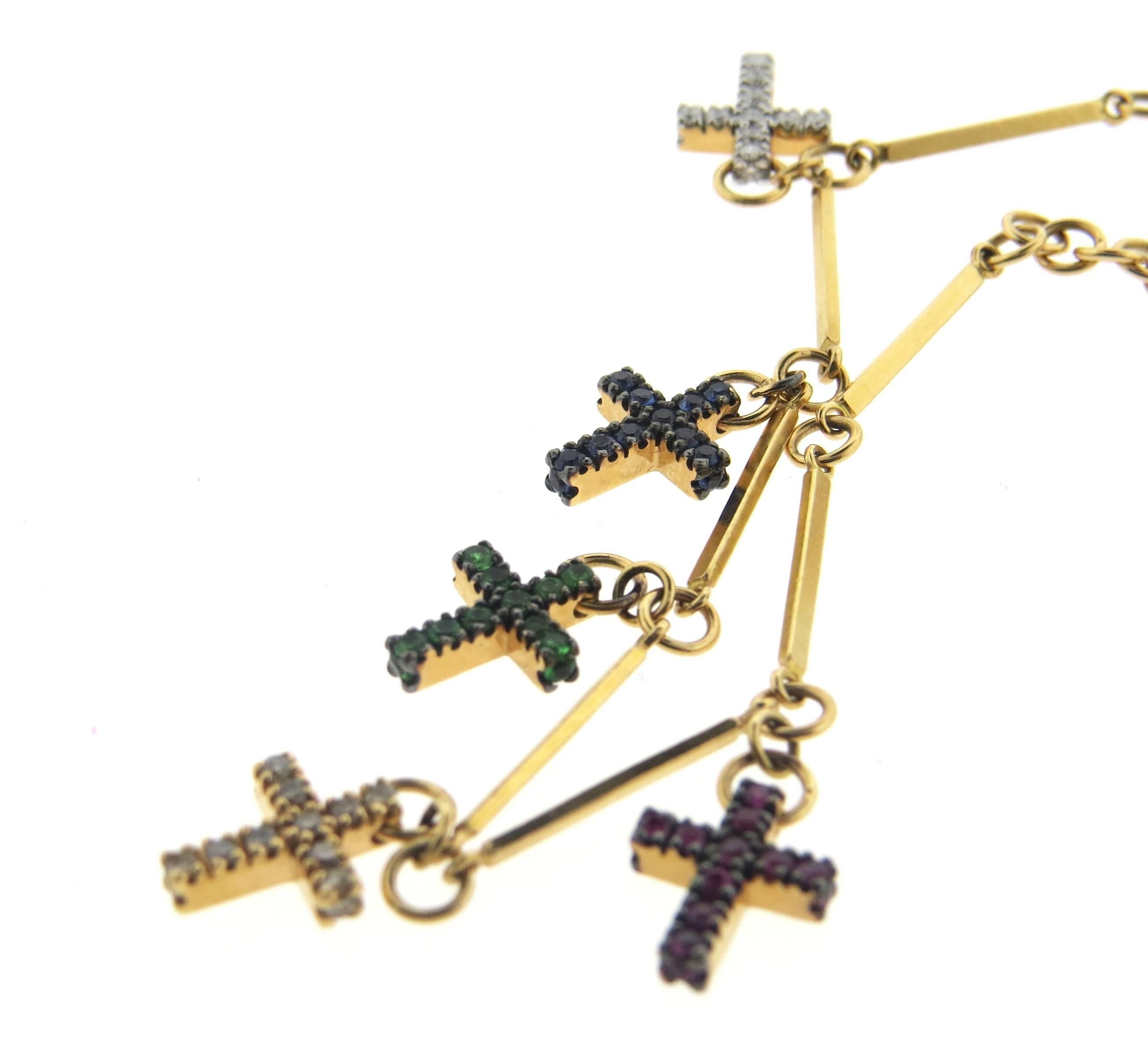 New 18k rose gold charm bracelet, crafted by Pomellato for Glory collection, featuring five cross charms, decorated with fancy diamonds, emeralds, rubies, tsavorites and sapphires. Bracelet is 6 1/2