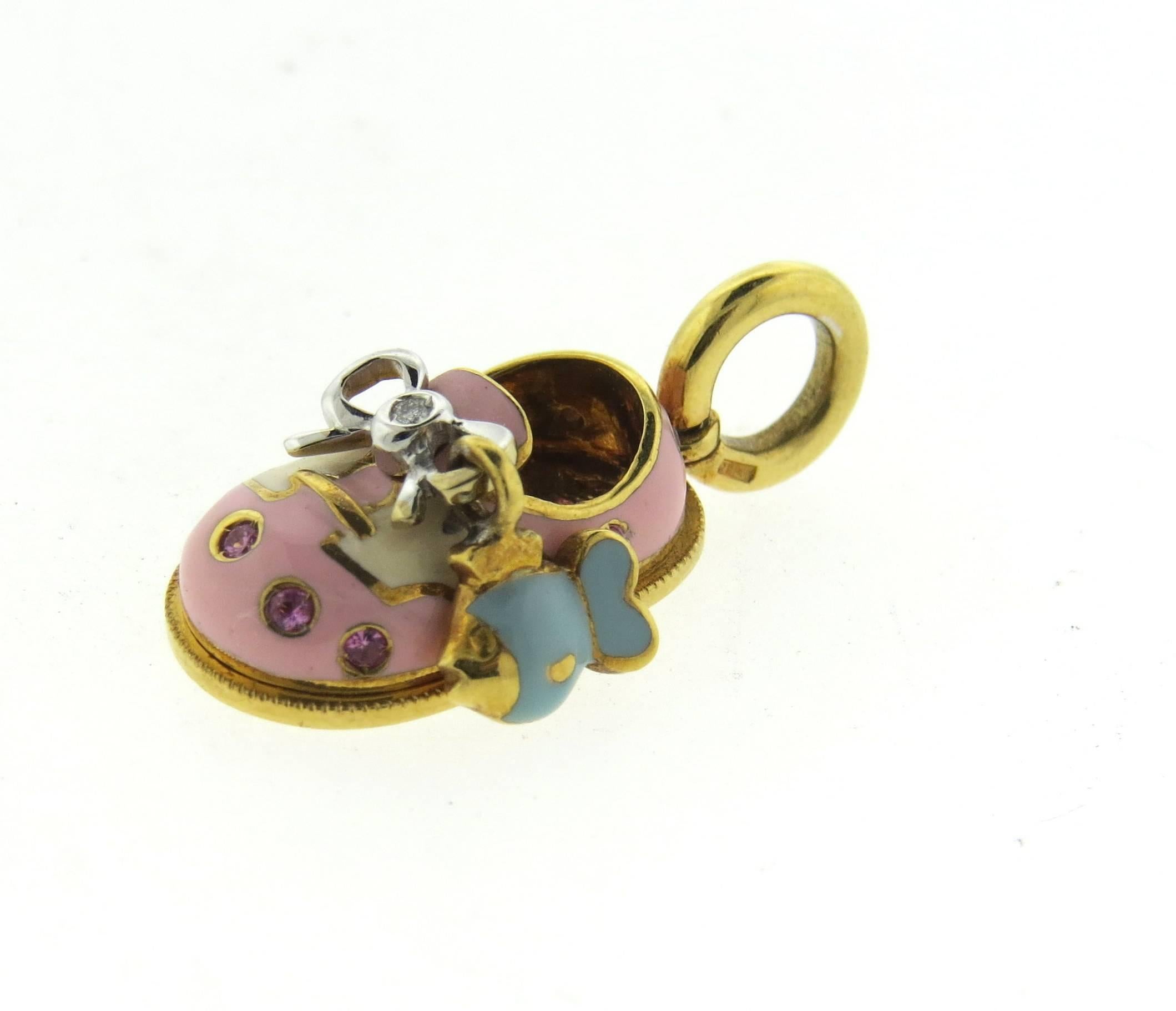 Adorable 18k yellow gold baby shoe charm, created by Aaron Basha, decorated with movable fish charm, diamonds, pink sapphires and enamel. Charm is 27mm long with bale x 11.3mm wide. Weight of the piece - 8 grams
Retail $2450