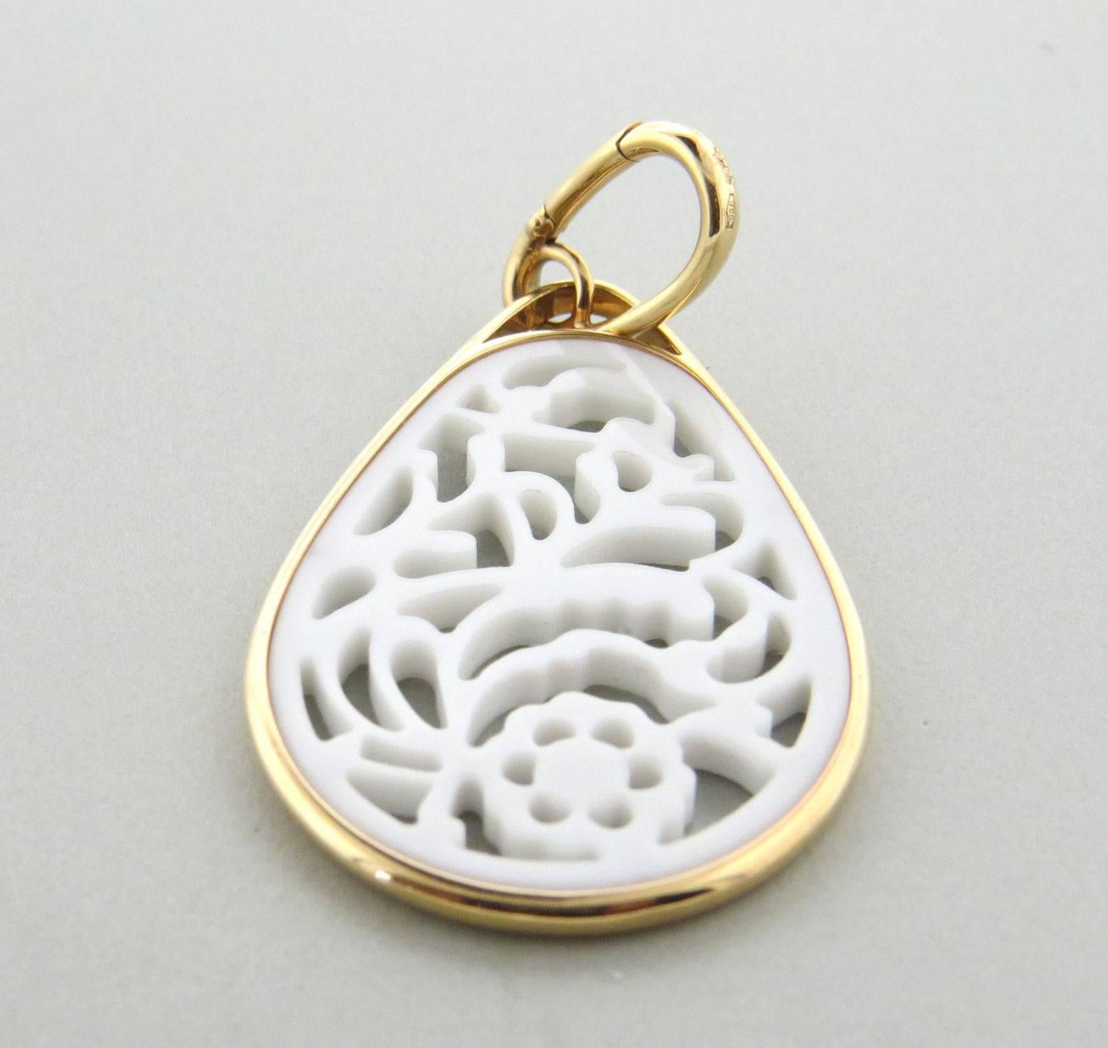 An 18k rose gold pendant set with a carved white agate.  Crafted by Pomellato, the pendant is 56mm long x 29mm and weighs 7.8 grams.  Marked: Pomellato, 750. Current Retail: $2750