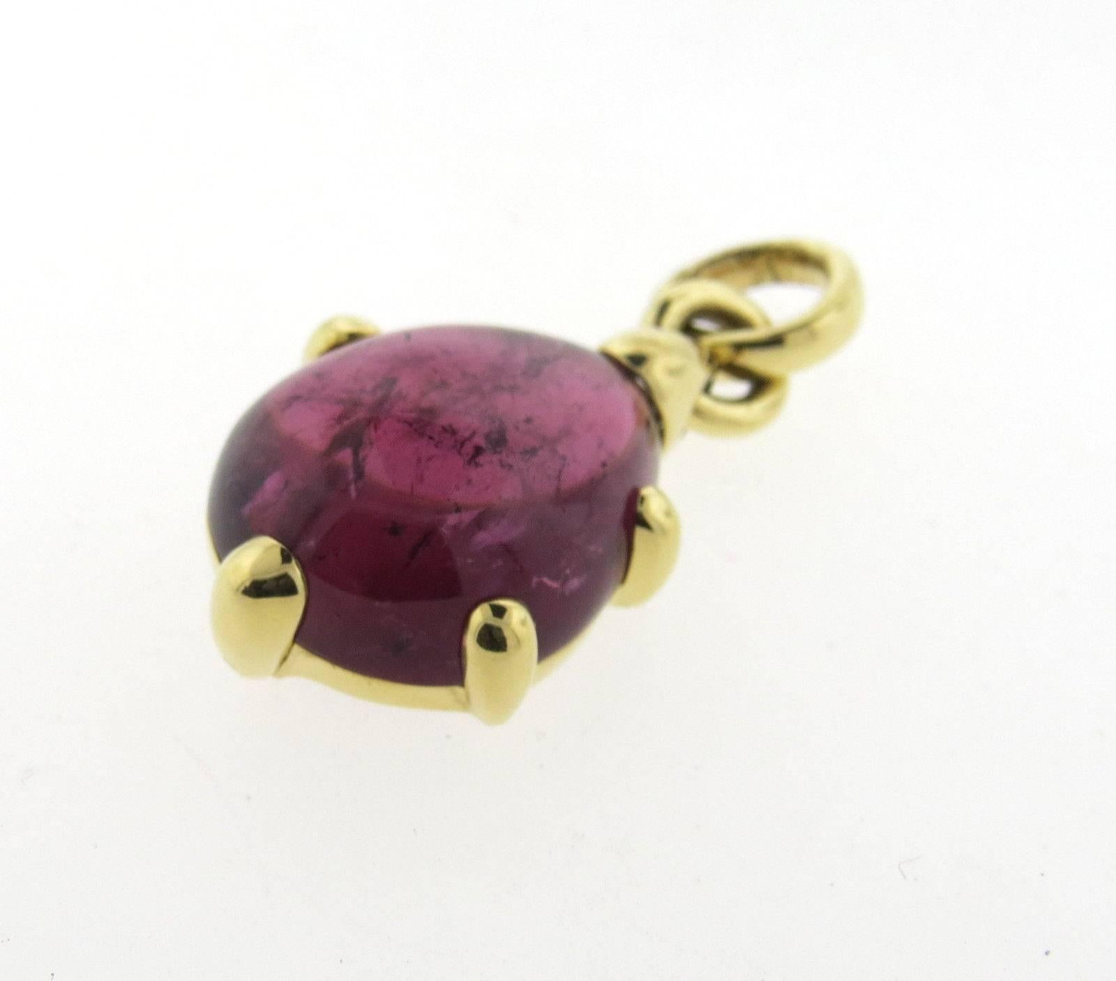 An 18k yellow gold pendant set with a pink tourmaline measuring 21.7mm x 17mm x 8.1mm.  Crafted by Pomellato, the pendant measures 38mm with bale x 19mm.  The weight of the piece is 11.7 grams.  Marked: Pomellato 750.  Current Retail: $7000