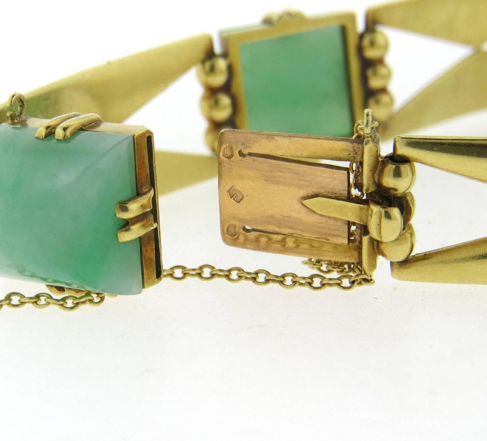 An 18k yellow gold bracelet set with sugarloaf cut jade 12.4mm x 12.4mm.  The bracelet is 7 1/4