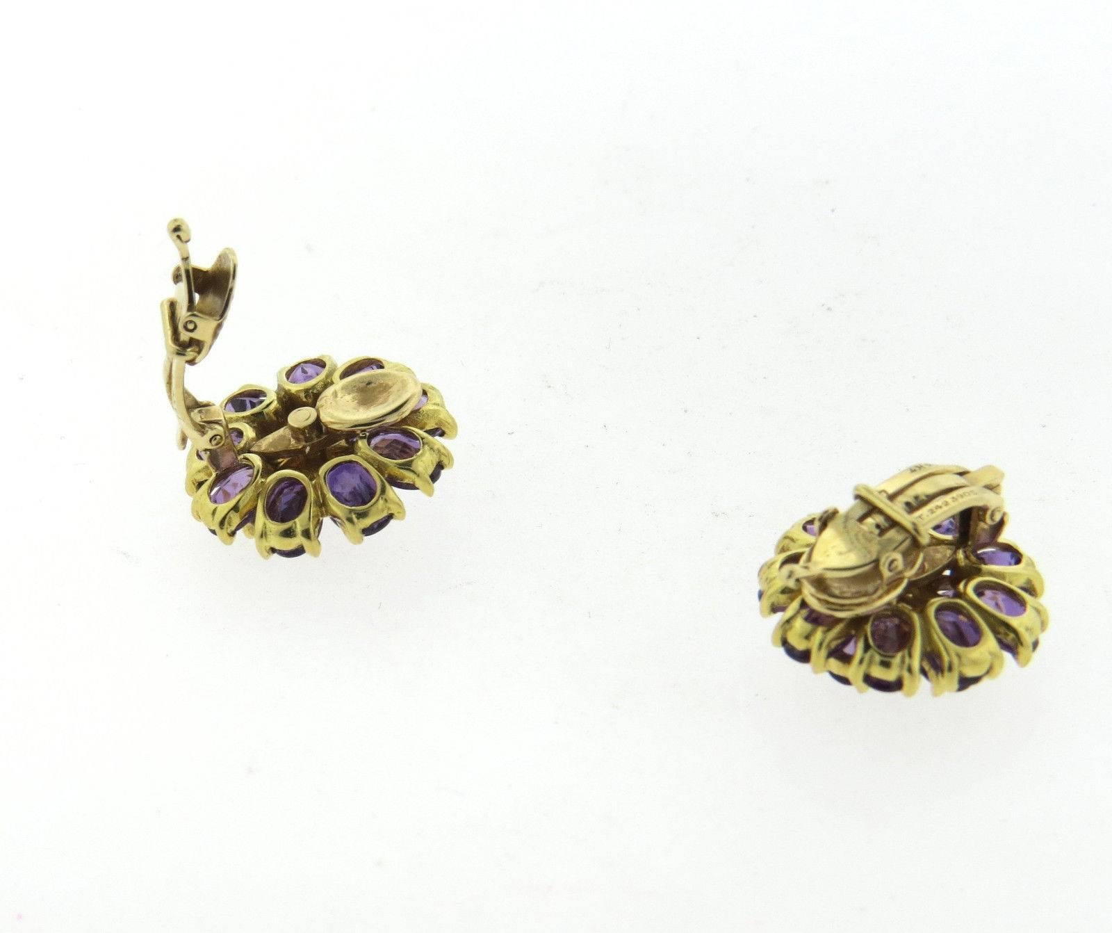 A pair of 14k yellow gold earrings set with amethyst and approximately 0.12ctw of diamonds. Earrings are 20mm in diameter and weigh 16.3 grams.  Marked: 14k, at.2423905