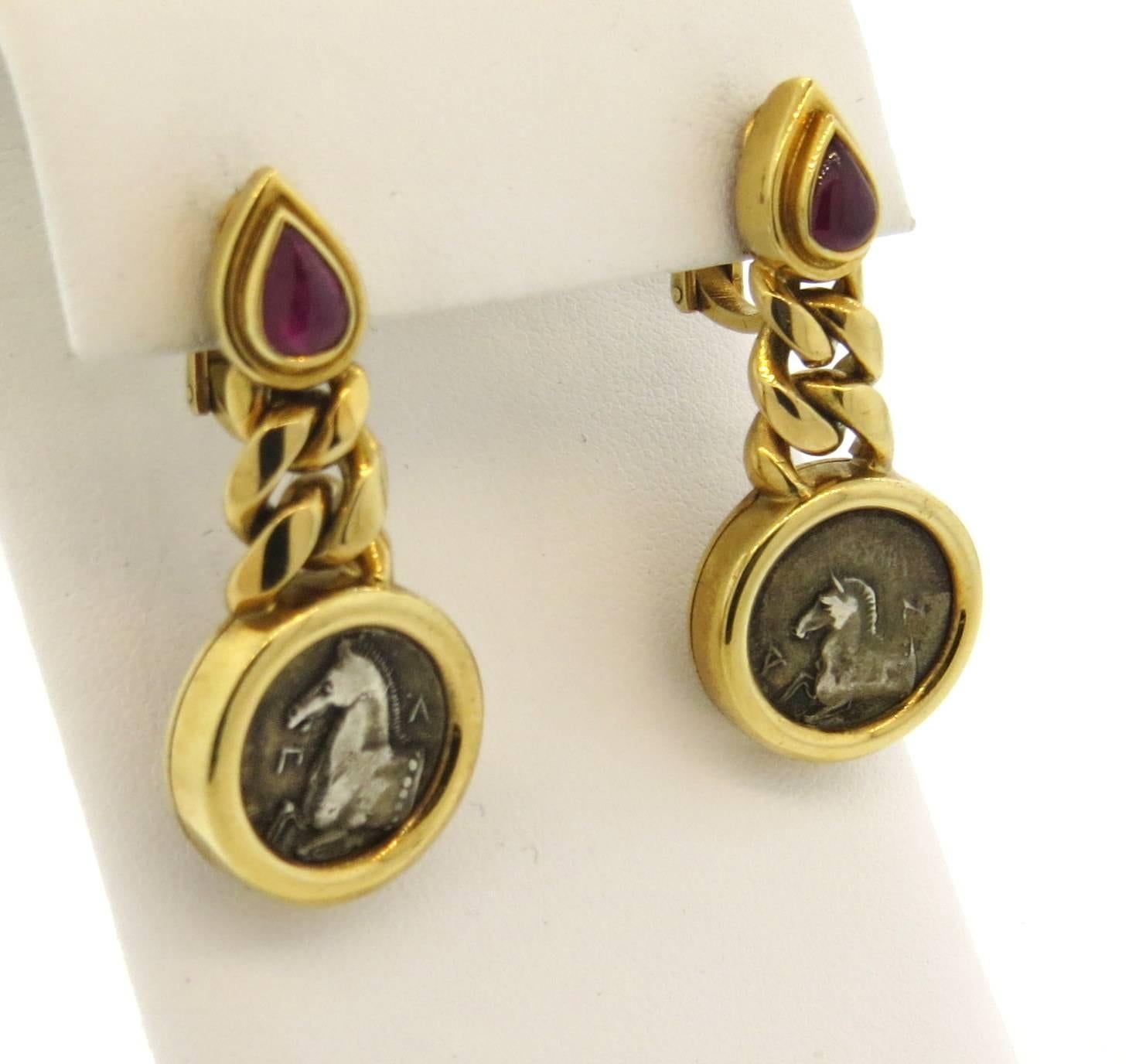 18k yellow gold Bulgari earrings, set with 13.5mm ancient coins and rubies. Earrings are 40mm long x 18mm at widest points (diameter of bottom) . Marked: Bvlgari, Thrace-Maroneia 4th cent. B.C, .B.A.2260,750.