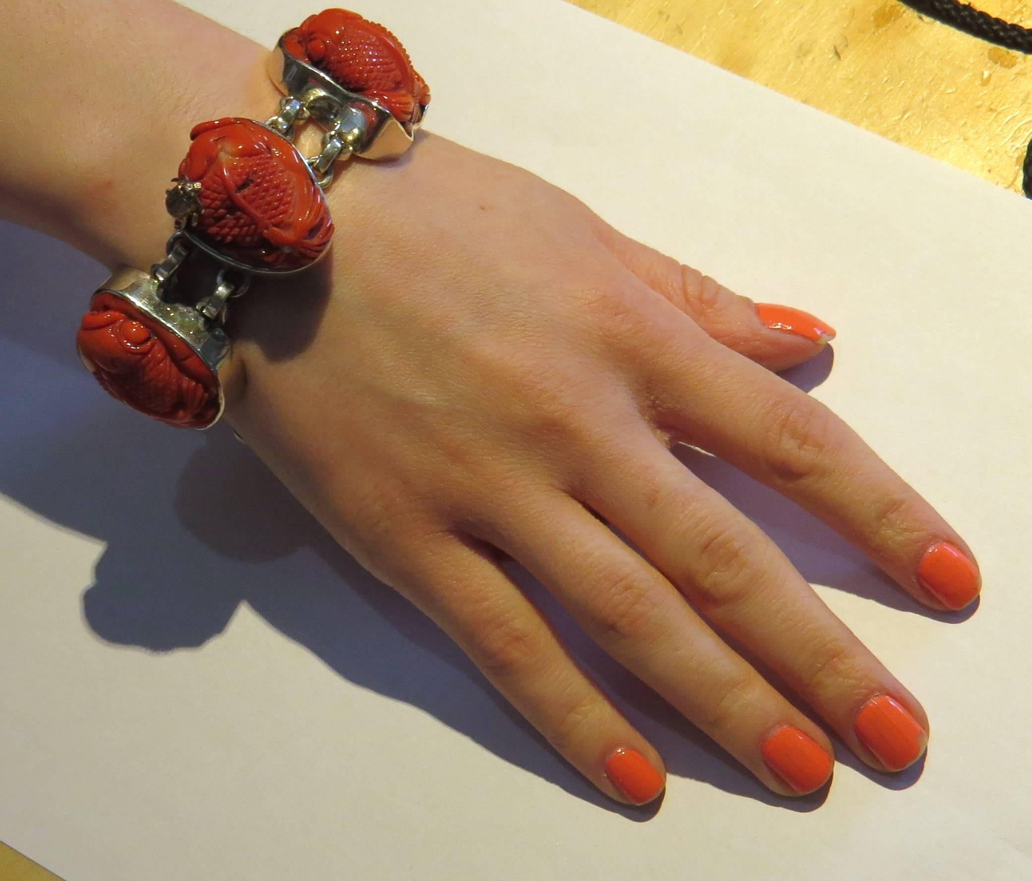 Chunky one of a kind sterling silver toggle bracelet, crafted by Stephen Dweck, set with five carved coral stations, featuring fish. Bracelet is 8 1/8