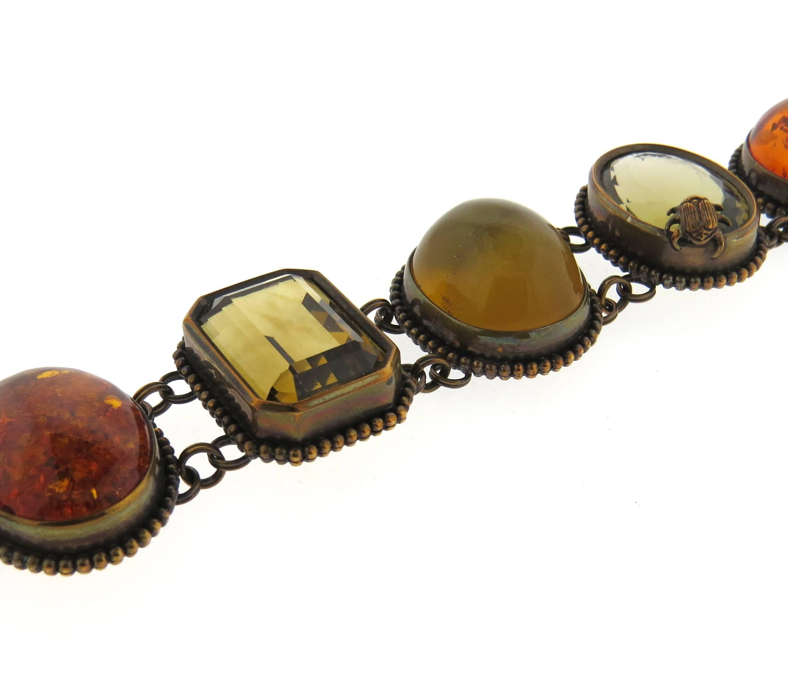 One of a kind bronze toggle bracelet, crafted by Stephen Dweck, set with multi color semi precious gemstones.  Bracelet is 8 3/7