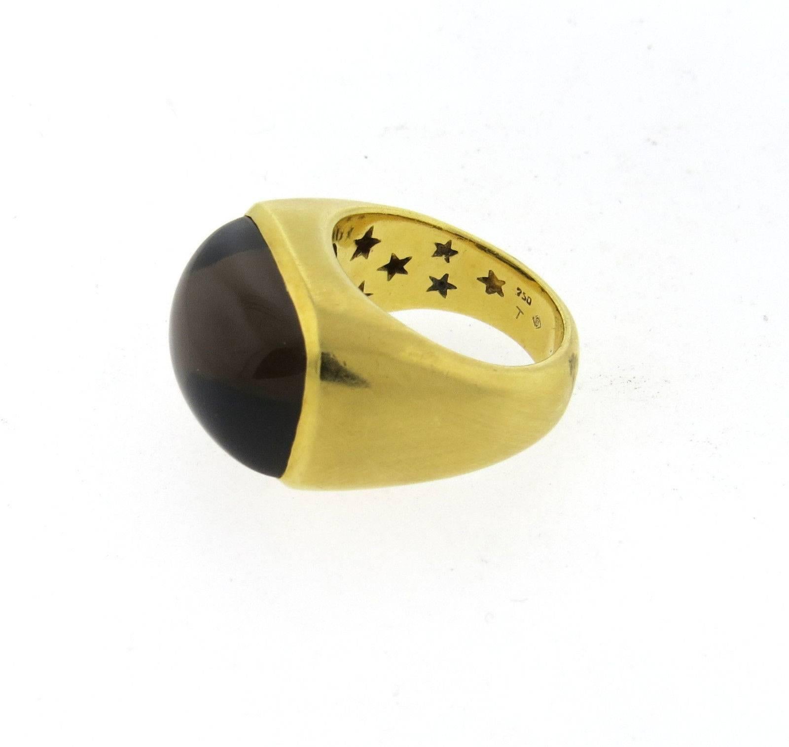 An Heavy 18k yellow gold ring set with a smokey topaz measuring 14.8mm x 19.5mm and a diamond accent.  Crafted by H. Stern, the ring is a size 8 1/2, ring top is 16mm x 22mm.  Marked: 750, T, S mark, signature Stars.  The weight of the ring is 23.2