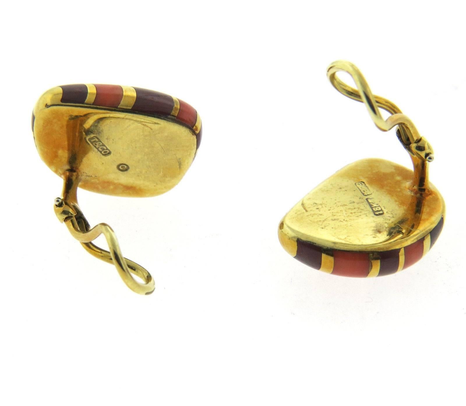 A pair of 18k yellow gold with a jasper and coral inlay.  Crafted by Tiffany & Co, the earrings measure 21mm x 17mm.  Marked: T & Co, 1979 18k.  The weight of the earrings is 18 grams.