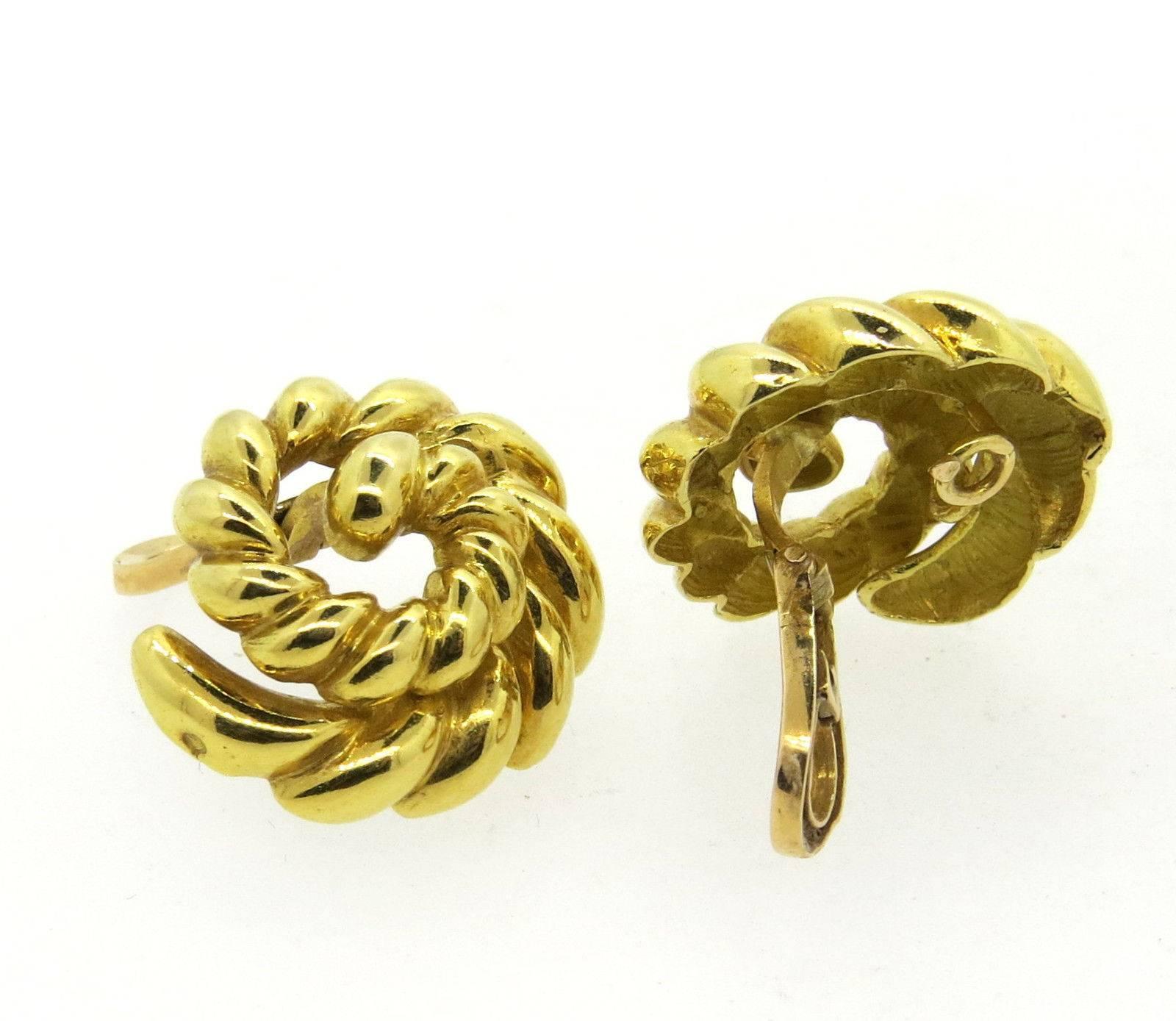 A pair of 18k yellow gold earrings in a swirl motif.  The earrings are 25mm in diameter and weigh 19.3 grams.