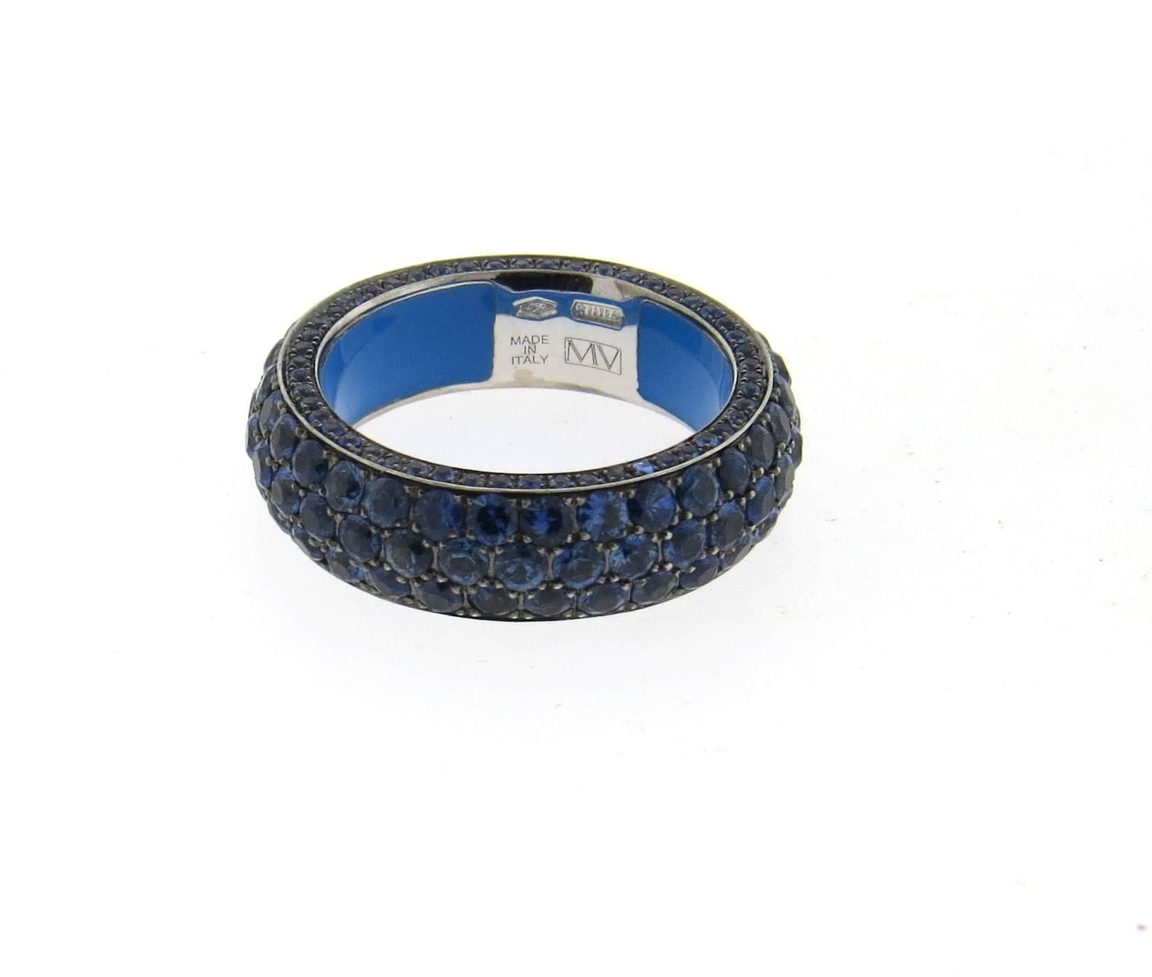 An 18k gold band ring, crafted by Marco Valente, set with all around 5.27ctw blue sapphire gemstones. Ring size 7, ring is 6.5mm wide and weighs 10.2 grams
Retail $6270