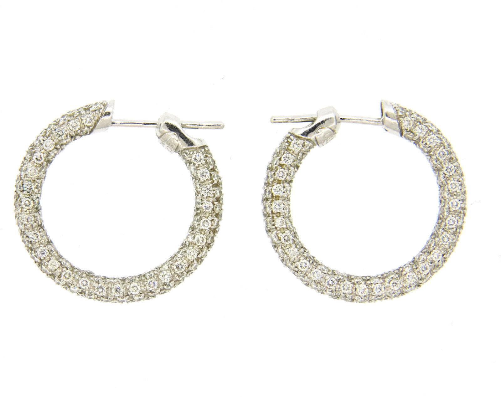A pair of 18k white gold earrings set with approximately 2.80ctw of G/VS diamonds.  Crafted by Leo Pizzo, the earrings measure 26mm in diameter and are 4.2mm wide.  Marked: 750,Leo Pizzo, Italian mark.  The weight of the earrings is 10.1 grams.
