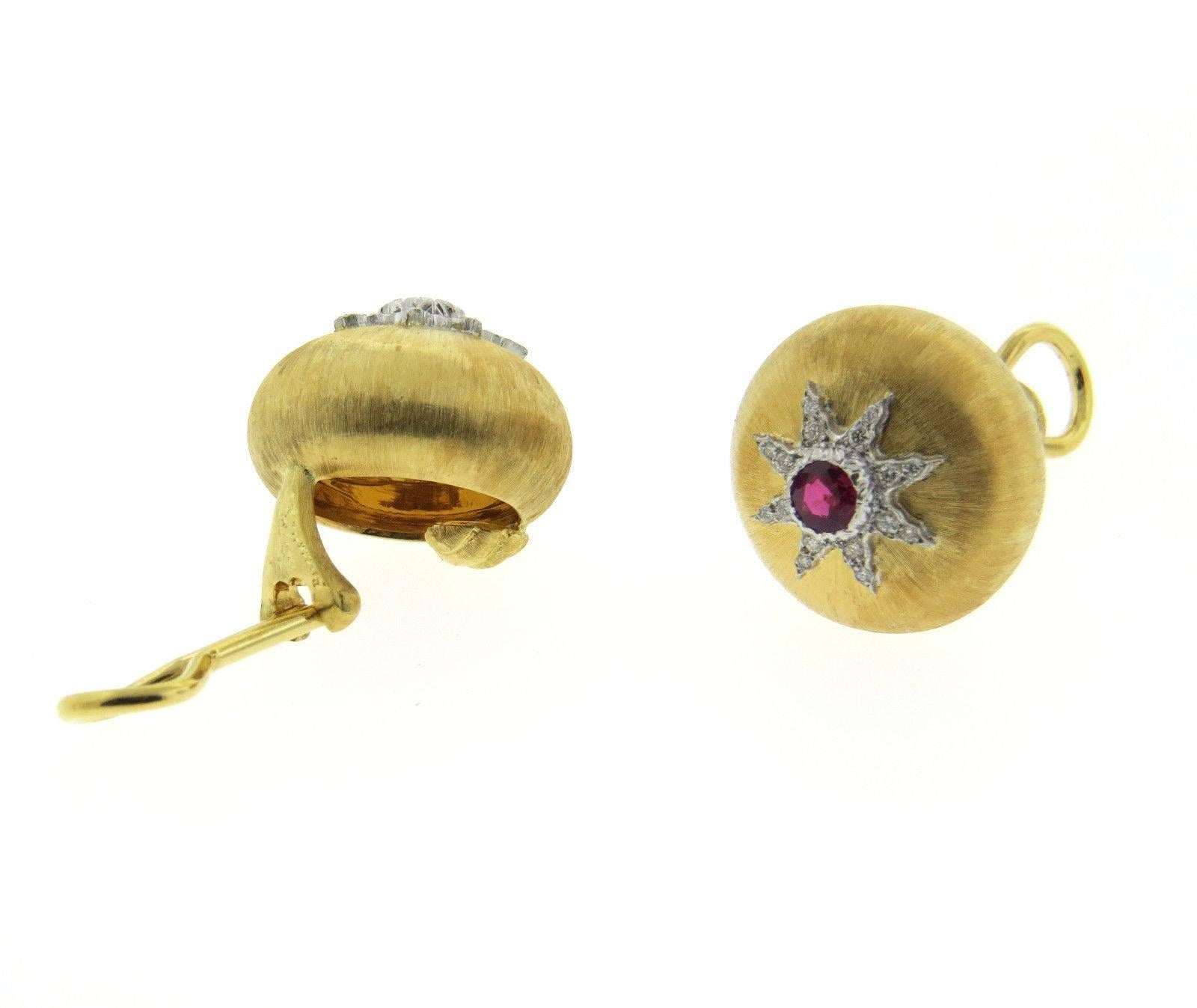 A pair of 18K yellow and white gold earrings set with rubies.  Crafted by Buccellati, the earrings measure 17mm in diameter and weigh 15.5 grams.  Marked: Buccellati, Italy, 18k.
