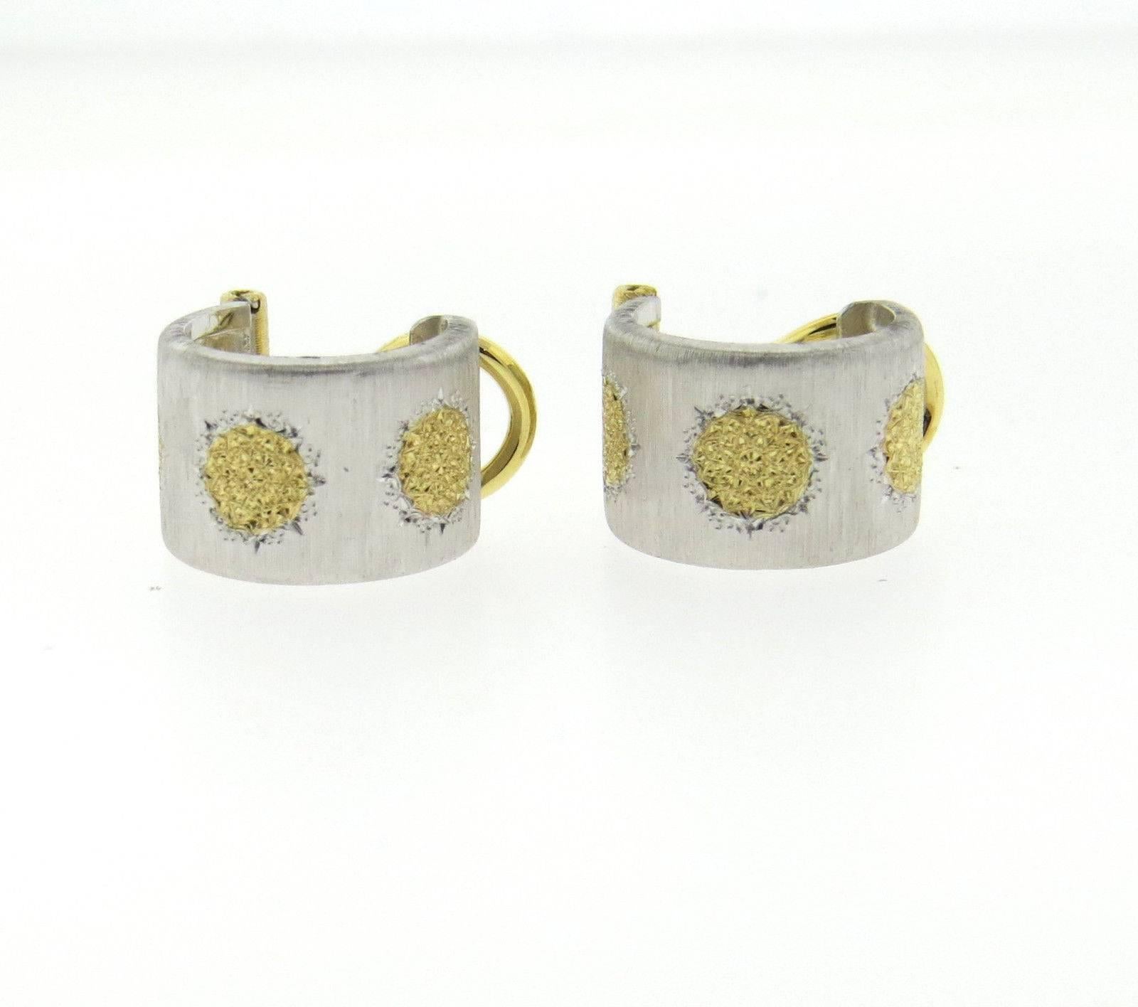 A pair of 18K yellow gold and sterling silver earrings by Buccellati.  The earrings measure 10mm wide and 14mm in diameter and weigh 7.8 grams.  Marked: Buccellati, 750, L5387.  Come with original Buccellati paperwork. Retail $4490.  