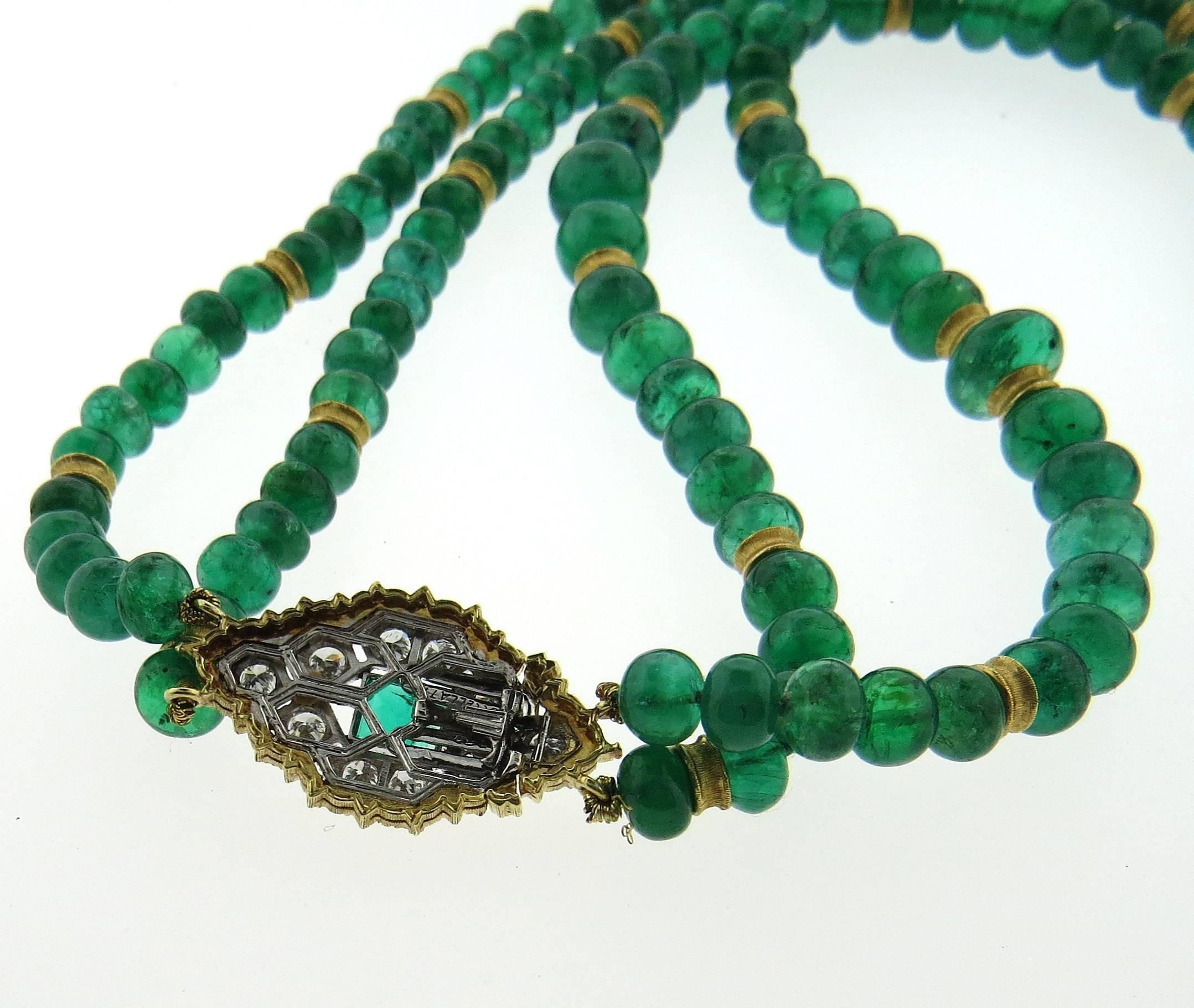 An 18k gold two strand necklace, crafted by Buccellati, featuring 5.5mm - 8mm emerald beads, and gold clasp, adorned with approximately 0.56ctw in G/VS diamonds and a rectangle emerald. Necklace with the clasp is 19 1/2