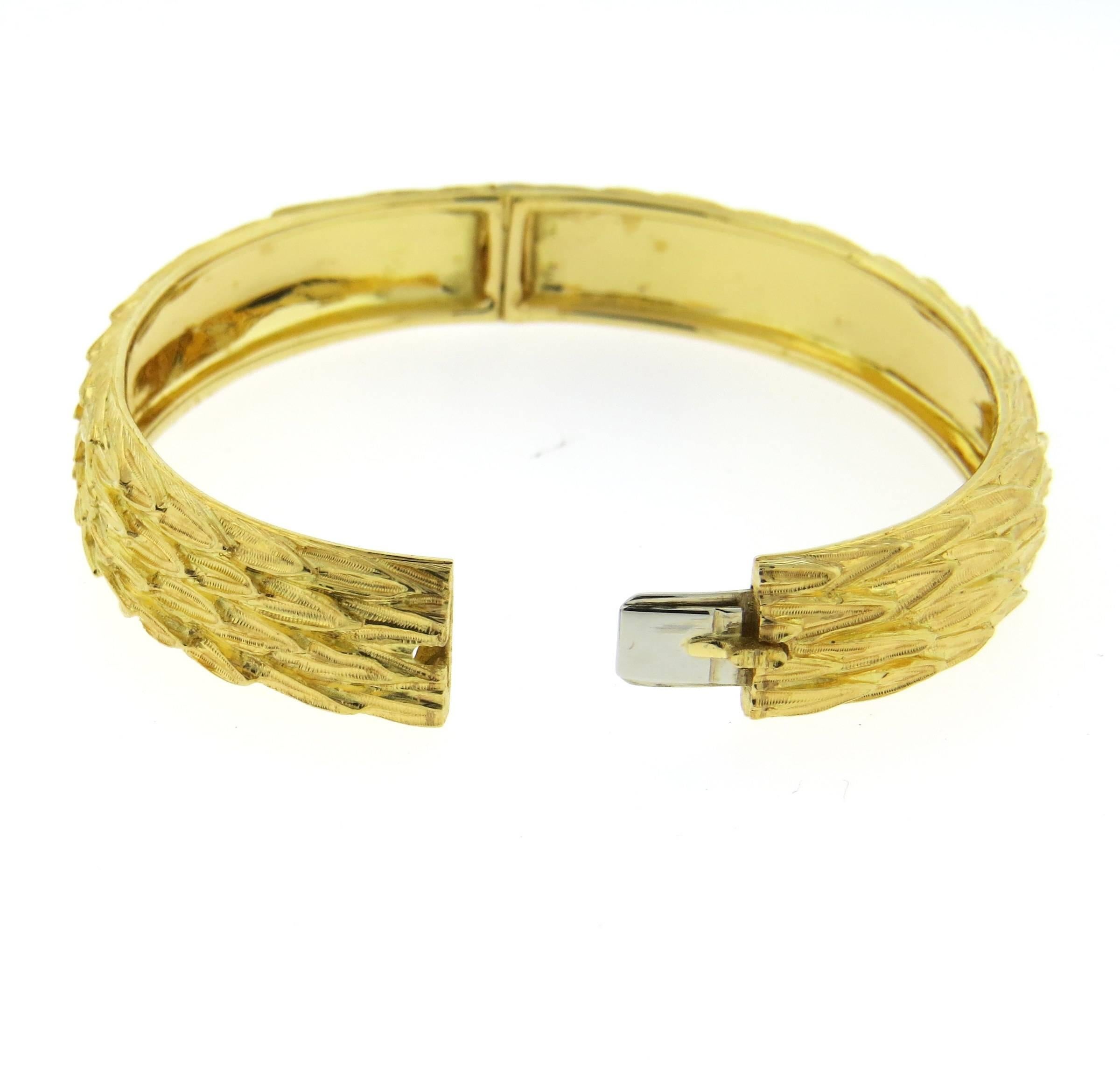 An 18k yellow gold textured finish bangle bracelet, crafted by Buccellati. Bracelet will comfortably fit up to 7