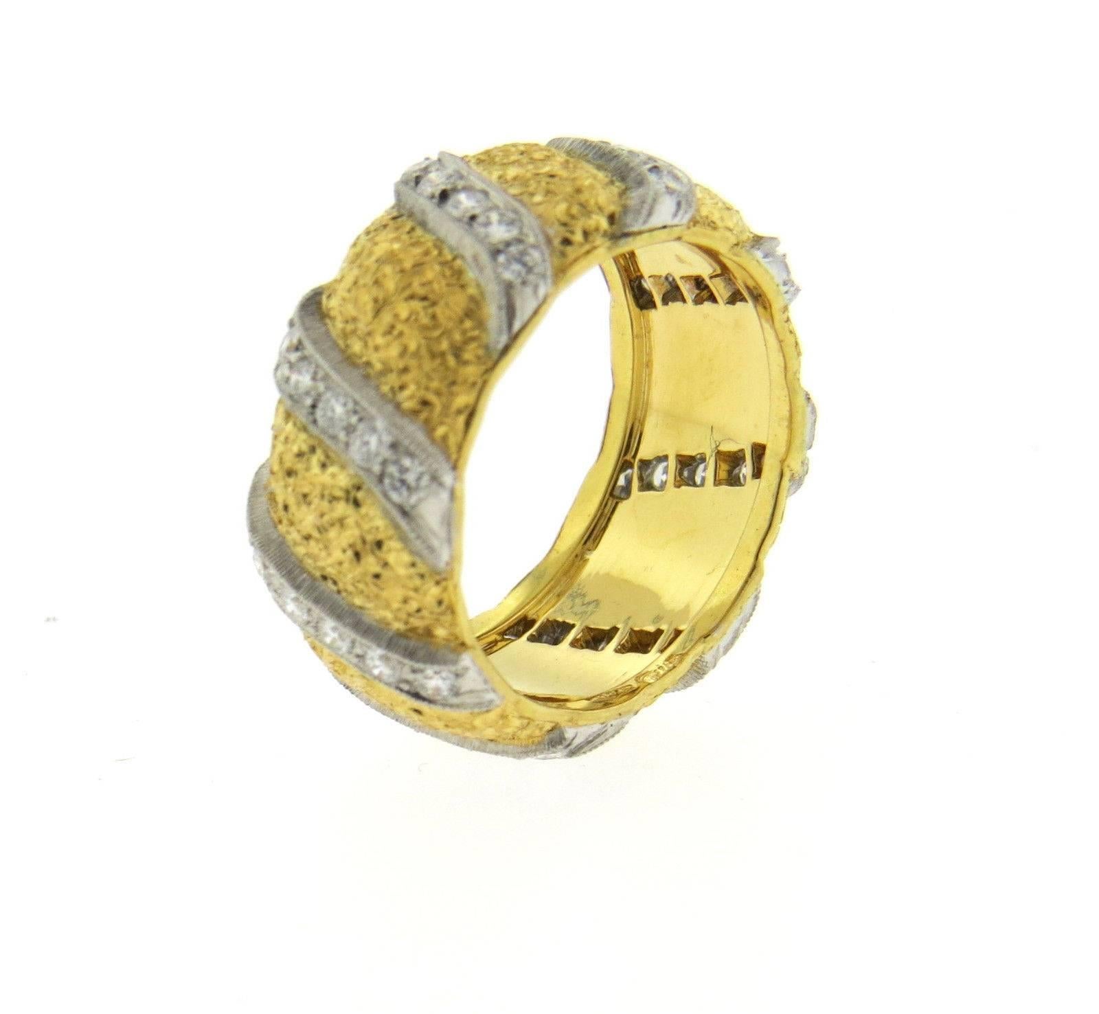 An 18k yellow gold band ring set with approximately 0.55ctw of G/VS diamonds.  Crafted by Mario Buccellati, the ring is a size 5 and is 8.5mm wide.  The weight of the piece is 9.6 grams. Marked: 750, M. Buccellati, Q2027.  The current retail of the