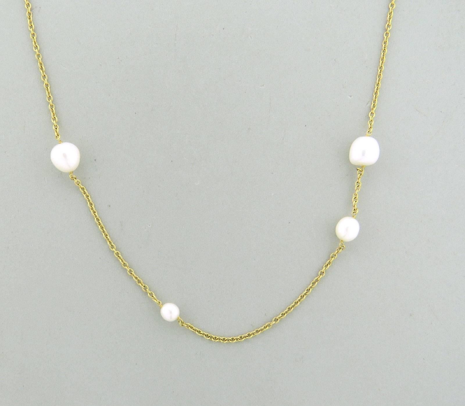 An 18k yellow gold necklace set with pearls ranging in size from 6.4mm to 10mm.  The necklace is 36