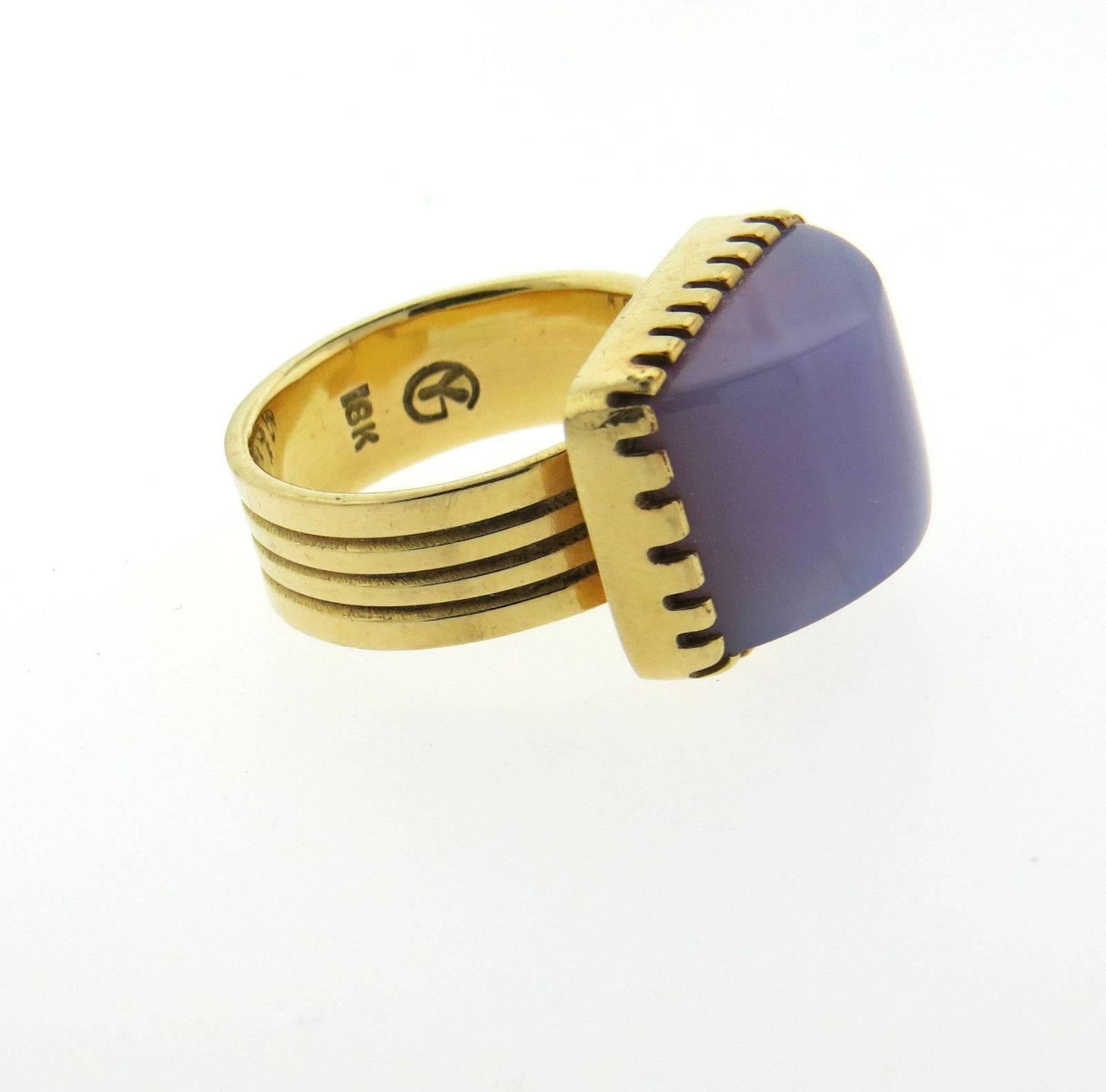 An 18k yellow gold ring set with chalcedony.  The ring is a size 7 3/4, ring top is 14mm x 18mm.  Marked: Maker's mark GY and 18k.  The weight of the ring is 13.5 grams.