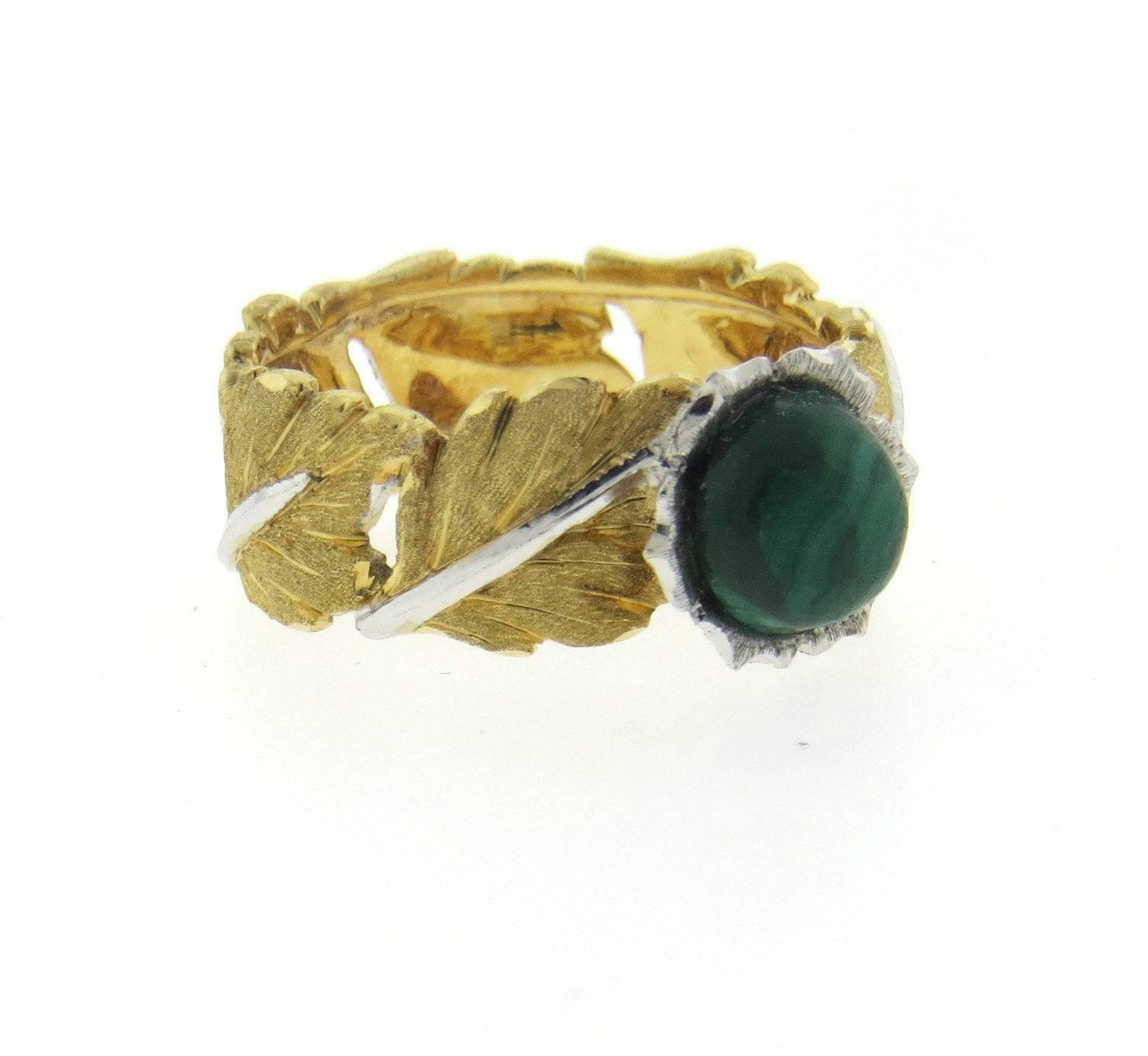 An 18k yellow and white gold ring set with a 7mm malachite cabochon. Crafted by Buccellati, the ring is a size 7 and 8.4mm wide. The weight of the ring is 7.2 grams.  Marked: Buccellati, 750

