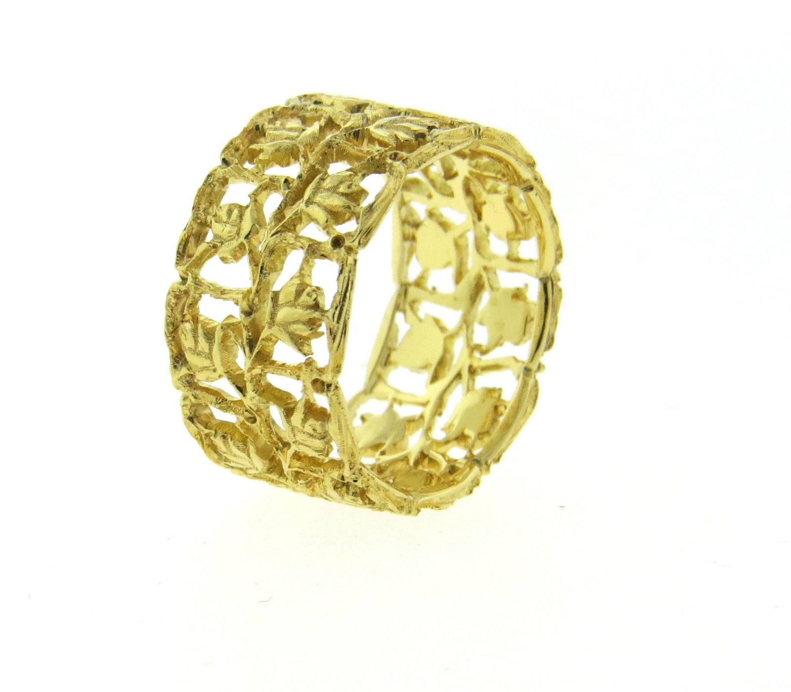 An 18k yellow gold floral wide band ring by Buccellati.  The ring is a size 6 and is 10mm wide.  The weight of the piece is 4.9 grams.  Marked: Italy, Buccellati 18k.  Comes with original Buccellati paperwork. Retail $4770.