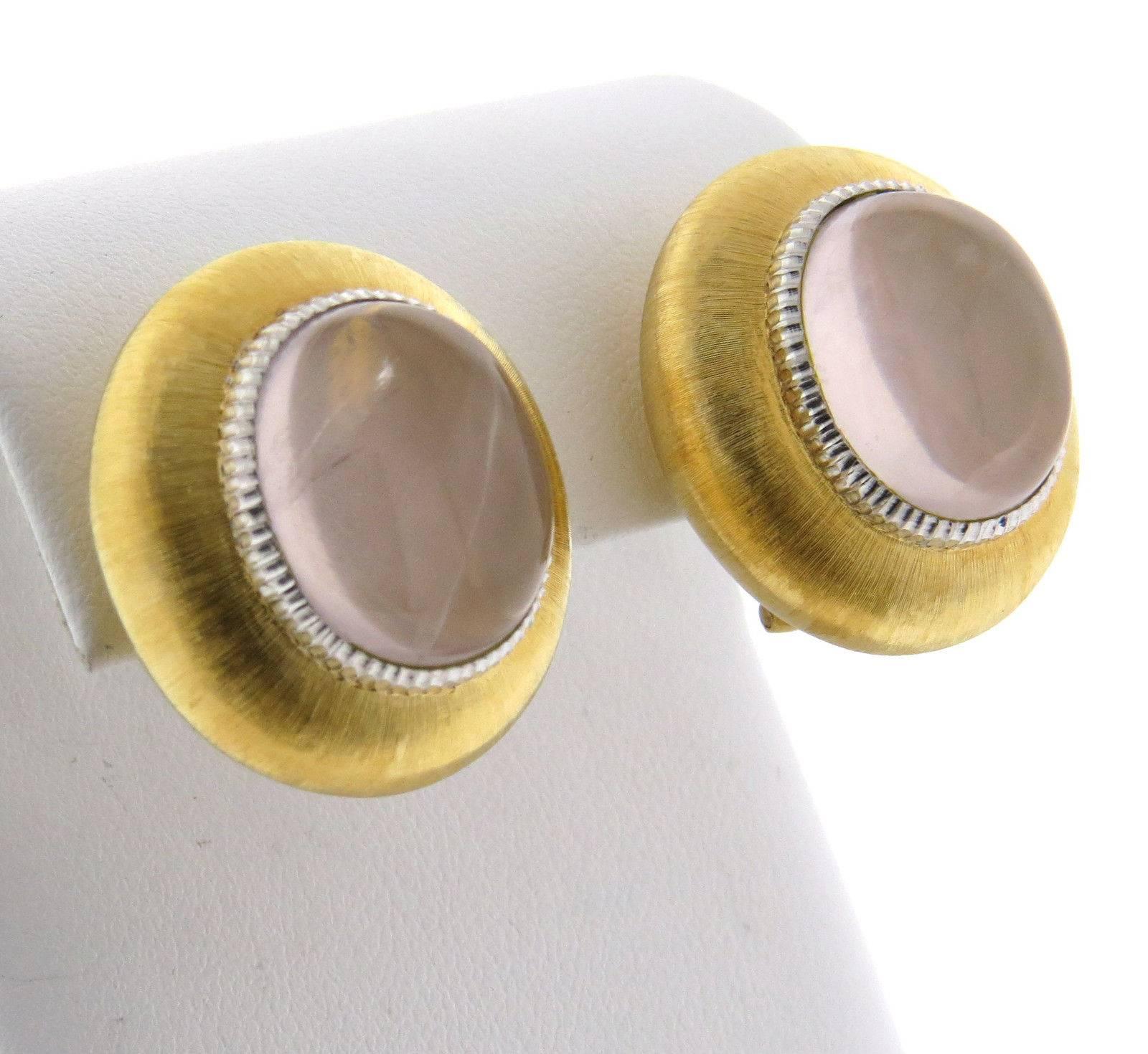 A pair of 18k yellow and white gold earrings set with rose quartz cabochons measuring 16.7mm x 14mm.  Crafted by Buccellati, the earrings measure 25mm x 22mm and weigh 24.9 grams.  Marked: Buccellati, Italy 18k. Come with original Buccellati