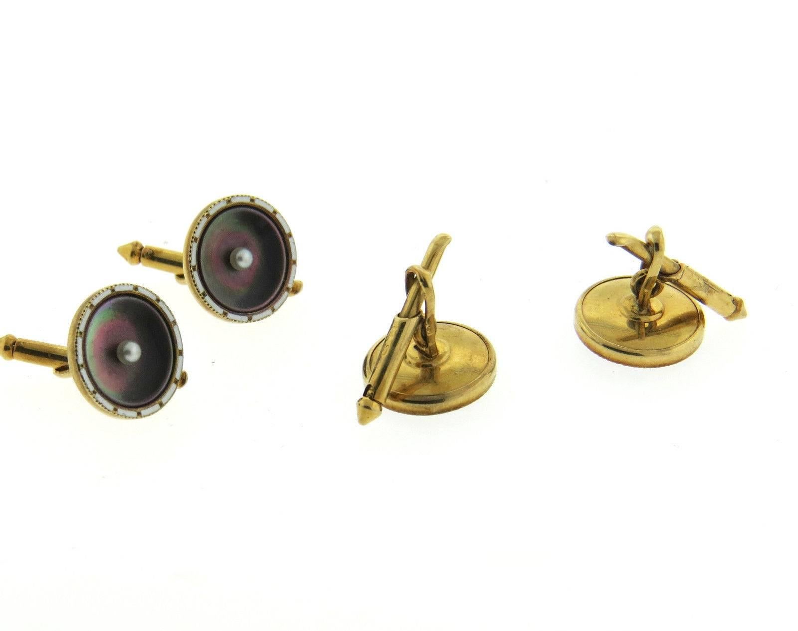 A 14k yellow gold stud set adorned with mother of pearl tops with seed pearls in the center. Each top measures 13mm in diameter and the cufflinks weigh 7.3 grams.  Marked: Maker's mark and 14k.
