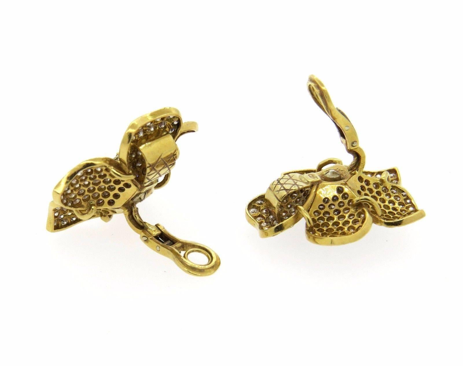 A pair of 18k yellow gold flower cocktail earrings set with approximately 9.50ctw in diamonds.  The earrings measure 33mm x 35mm and weigh 26 grams.