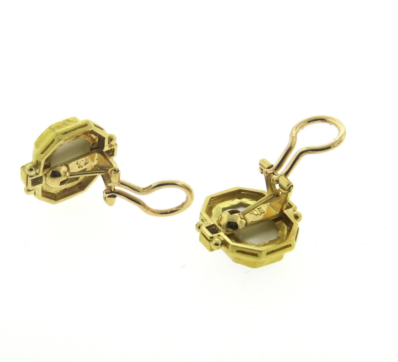A pair of 19k yellow gold earring set with venetian glass intaglio surrounded by iolite stones.  Crafted by Elizabeth Locke, the earrings measure 20mm x 19mm and weigh 17 grams.
