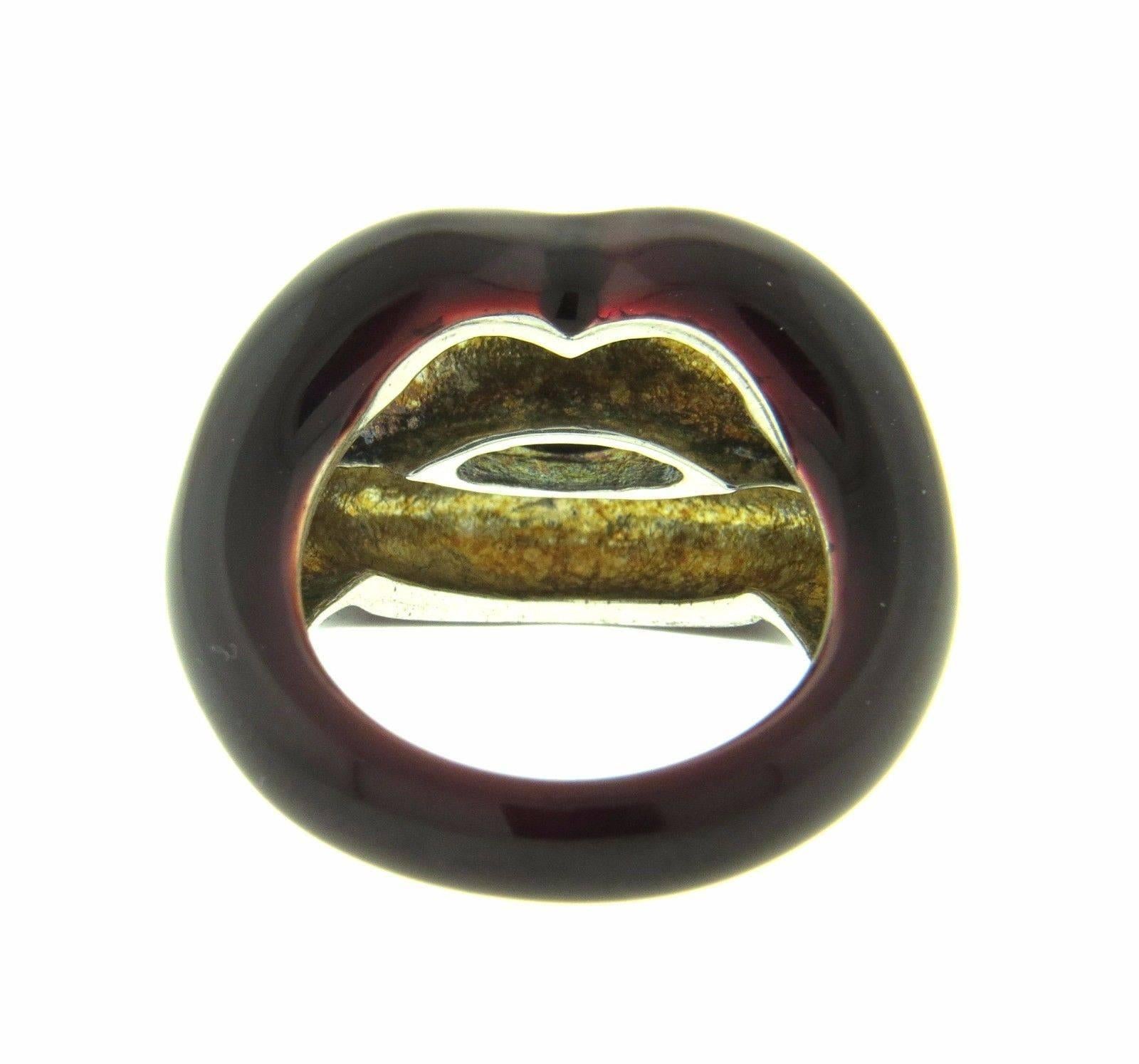 A sterling silver ring adorned with burgundy enamel.  The ring is a size 6.5, top measures 16mm at widest point.  The weight of the piece is 12.5 grams.  Marked: S-AP 925.