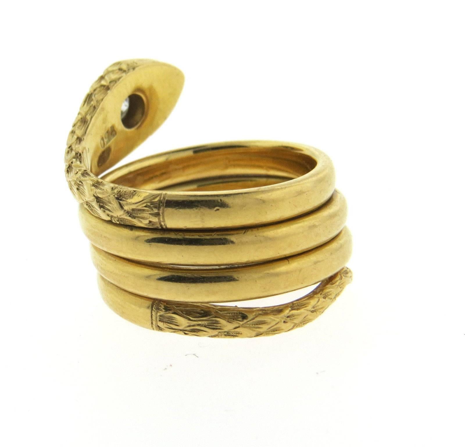 An 18k yellow gold snake ring set with 0.16ctw of G/VS diamonds.  The ring size 7 1/2, ring top is 17mm wide.  The weight of the ring is	15.7 grams.