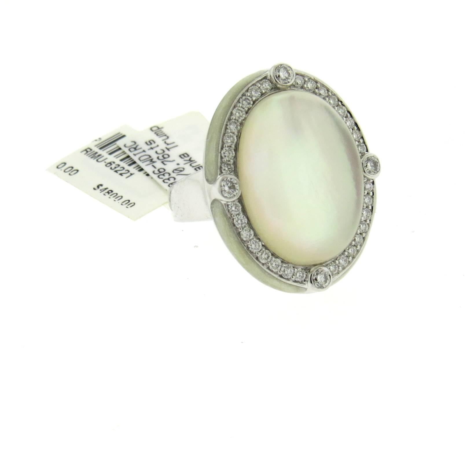 Large cocktail 18k white gold ring, crafted by Ivanka Trump, featuring crystal top, backed with mother of pearl, surrounded with approximately 0.76ctw in diamonds and enamel rim. Ring is a size 7 1/4, ring top measures 26mm x 21mm. Marked: Ivanka