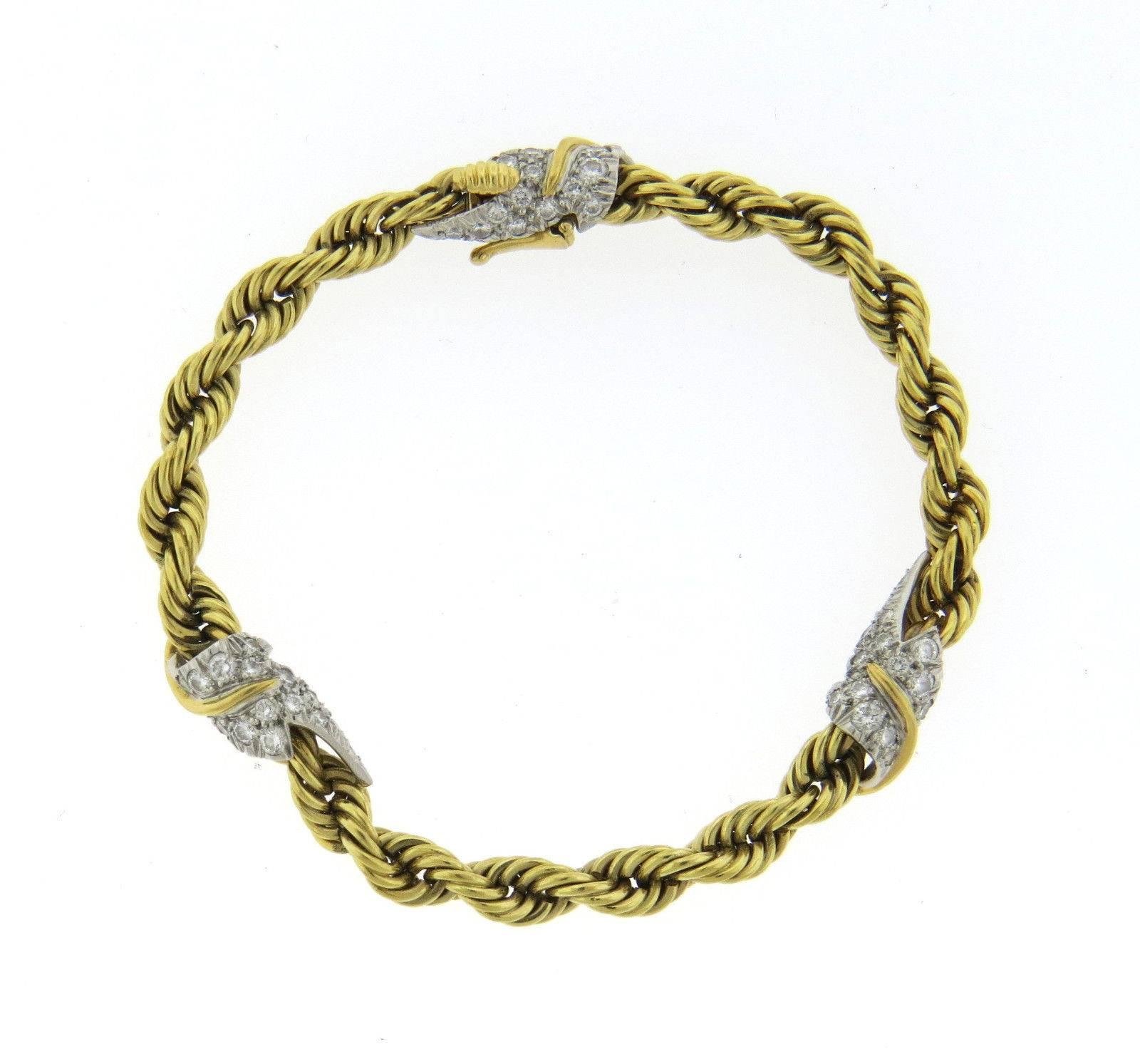 An 18k yellow gold and platinum bracelet set with approximately 0.78ctw of G/VS diamonds.  The bracele is  7 1/8