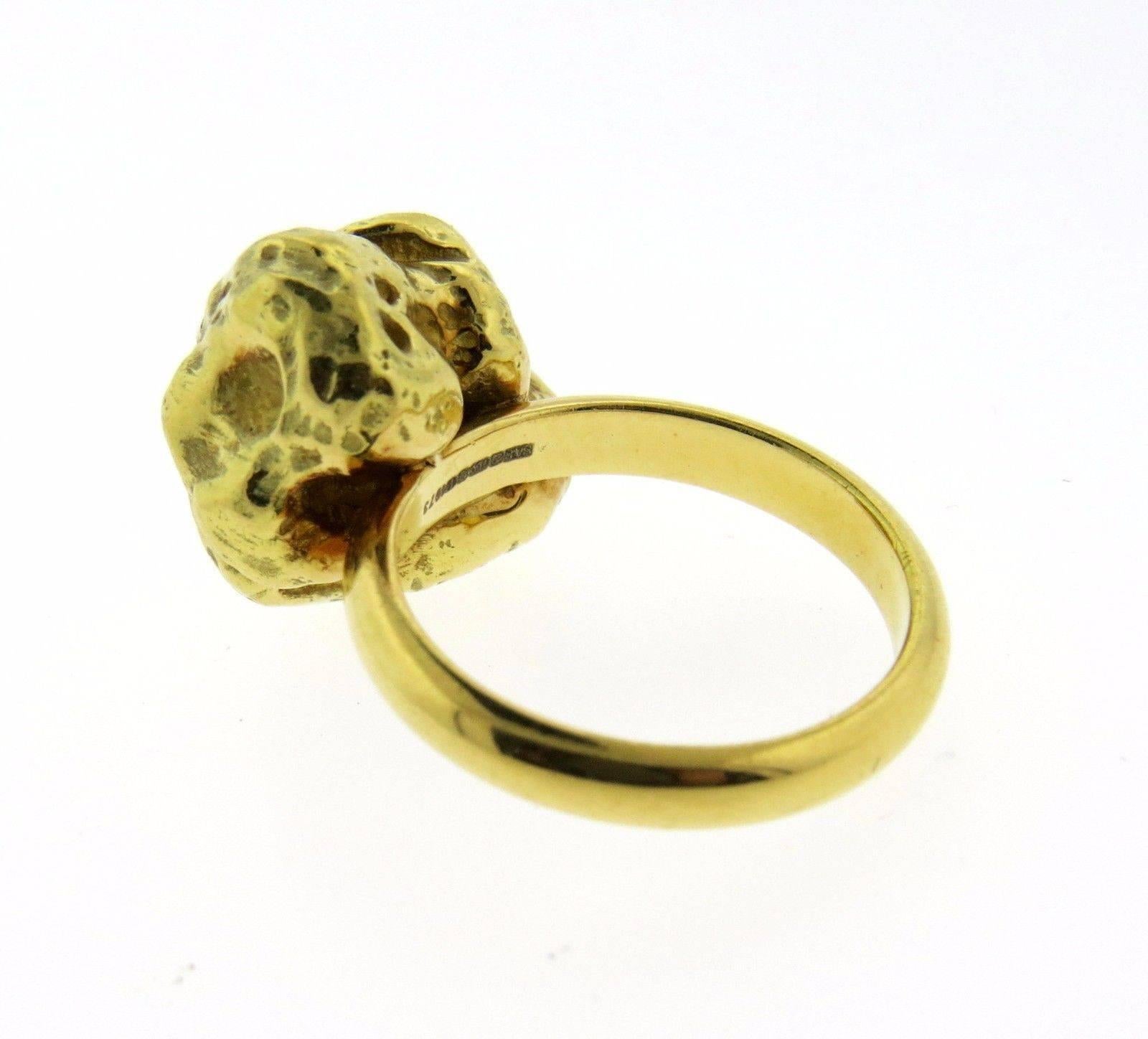 An 18K yellow gold nugget ring.  The ring is a size 6, top measures 15.8mm x 16mm.  The weight of the piece is 21.3 grams. 