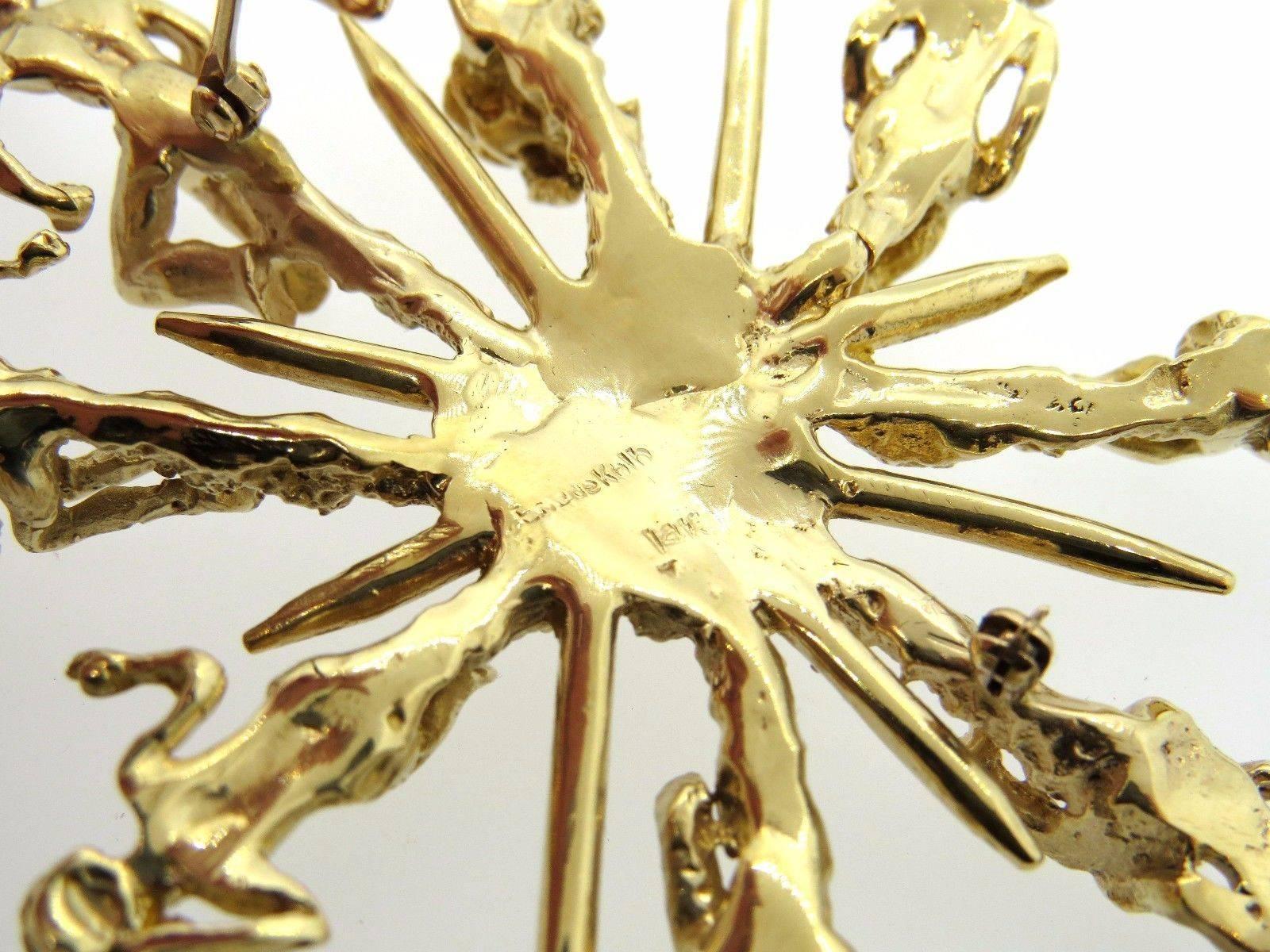 A 14K yellow gold brooch by Eric De Kolb.  The brooch measures 103mm x 72mm and weighs 57.3 grams.  Marked: Eric de Kolb 14K.