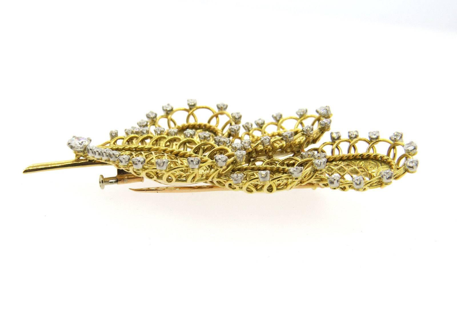 An 18k yellow gold brooch set with 3 carats of G/VS diamonds.  Crafted by Boucheron, the brooch measures 85mm x 45mm and weighs 35 grams. Marked with French assay marks, Boucheron Paris.