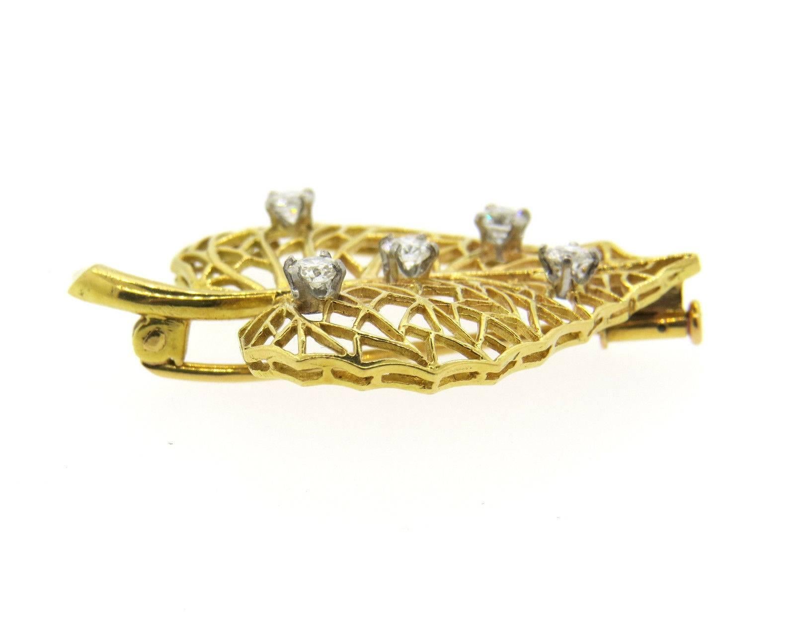 An 18k yellow gold leaf brooch set with approximately 0.70ctw of G/VS diamonds.  The brooch measures 40mm x 29mm and weighs 6.9 grams.  Marked: made in France, Cartier, 18ct.