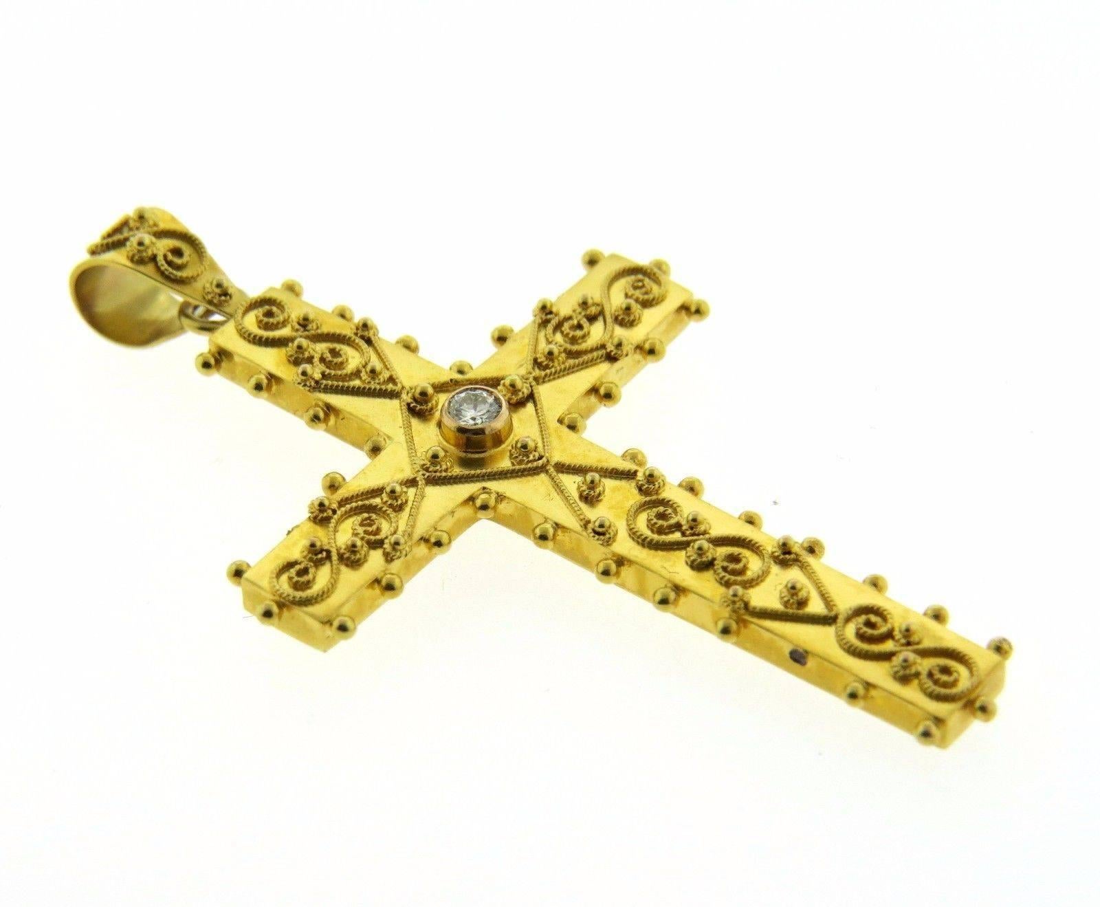 A 15k gold cross pendant set with a 0.06ct G/VS diamond.  The piece measures 55mm (including bale) x 33mm and wieghs 5.2 grams.
