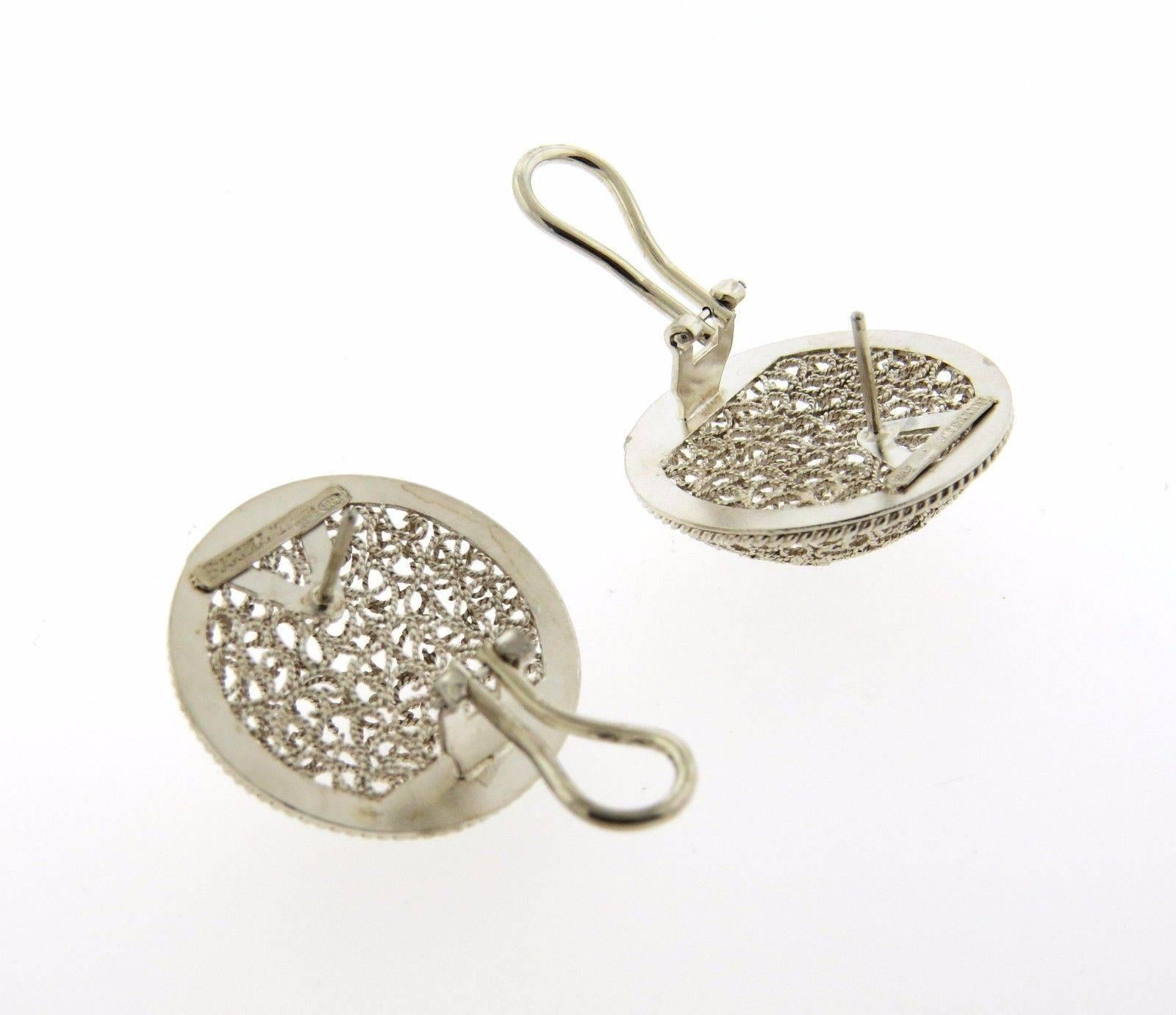 A pair of sterling silver round earrings by Buccellati.  The earrings measure 26mm in diameter and weigh 8.6 grams.  Marked: Buccellati Italy 925.  The earrings come with Buccellati paperwork.
